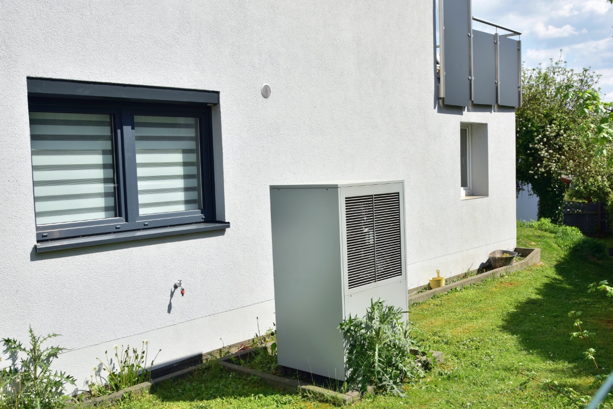 Außengerät einer Klimaanlage vor einem modernen Haus