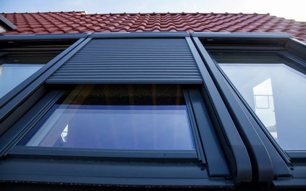 Velux Dachfenster mit blockiertem Außenrollladen – Rollladen klemmt halb geöffnet Velux Dachfenster mit blockiertem Außenrollladen – Rollladen klemmt halb geöffnet
