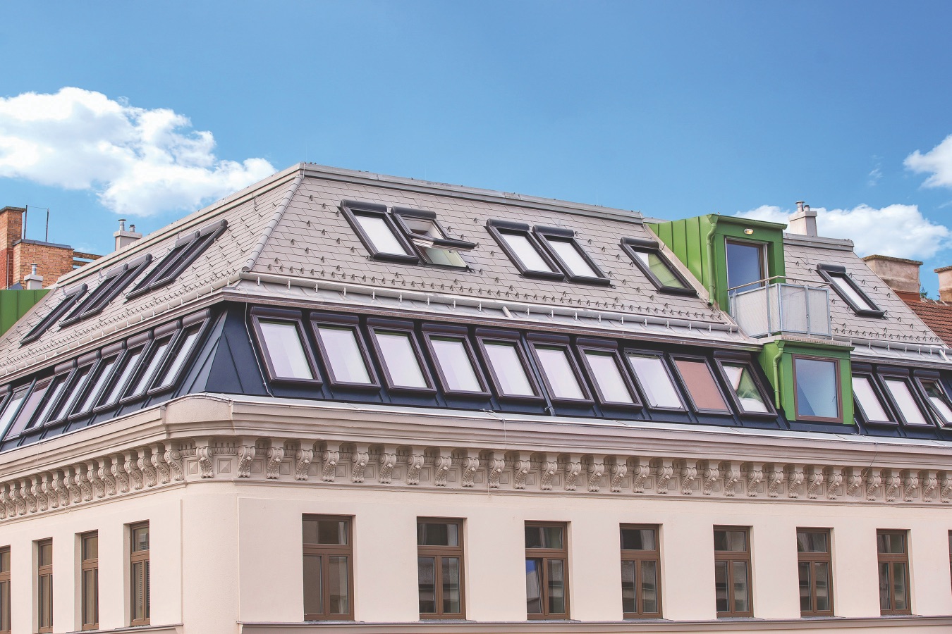 Mehrere moderne Dachfenster in einem Schrägdach mit Lärmschutzverglasung – effektiver Lärmschutz für Dachfenster in urbaner Umgebung.