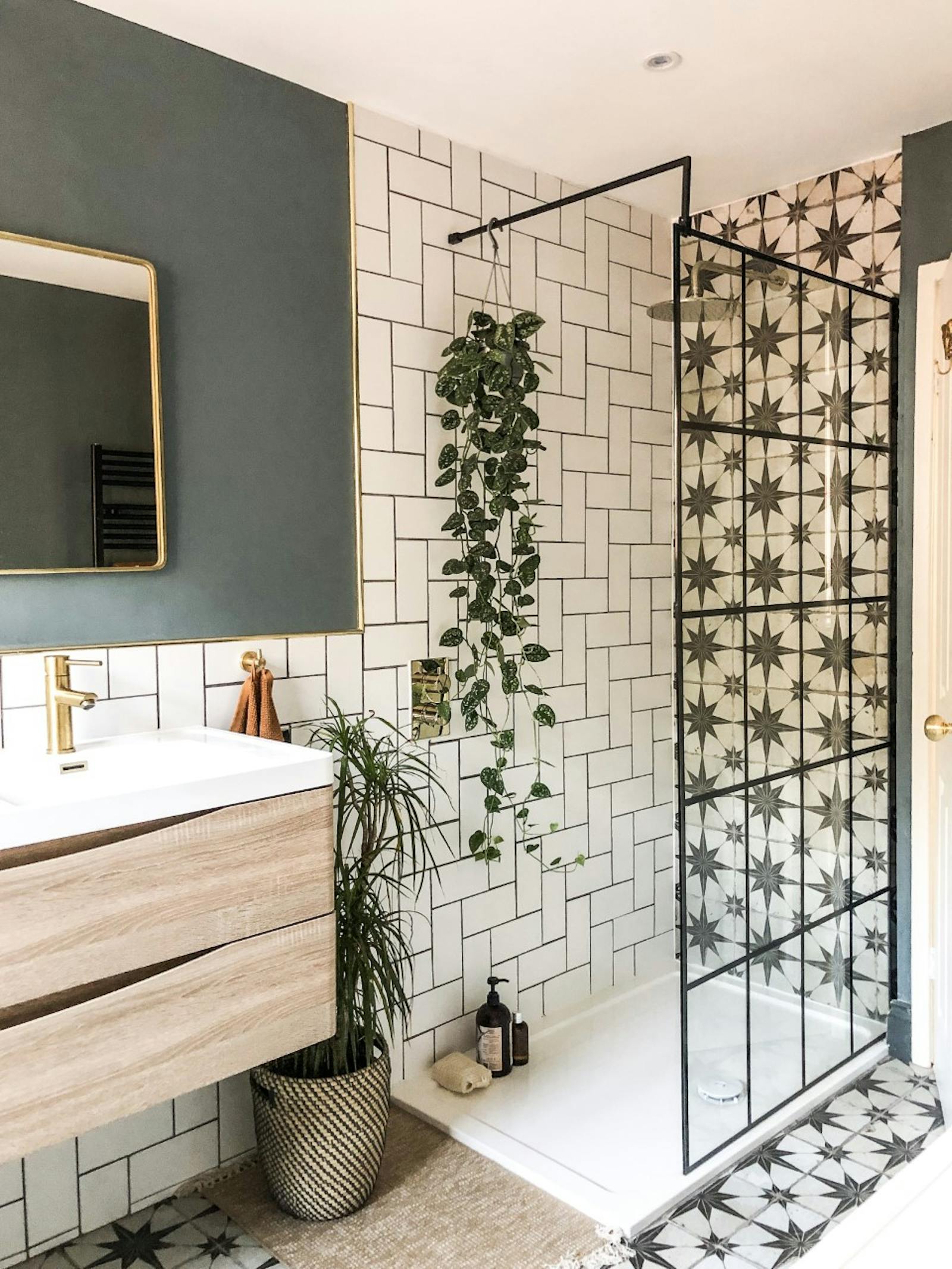Bathroom with white tiles and a teal-painted wall behind the mirror