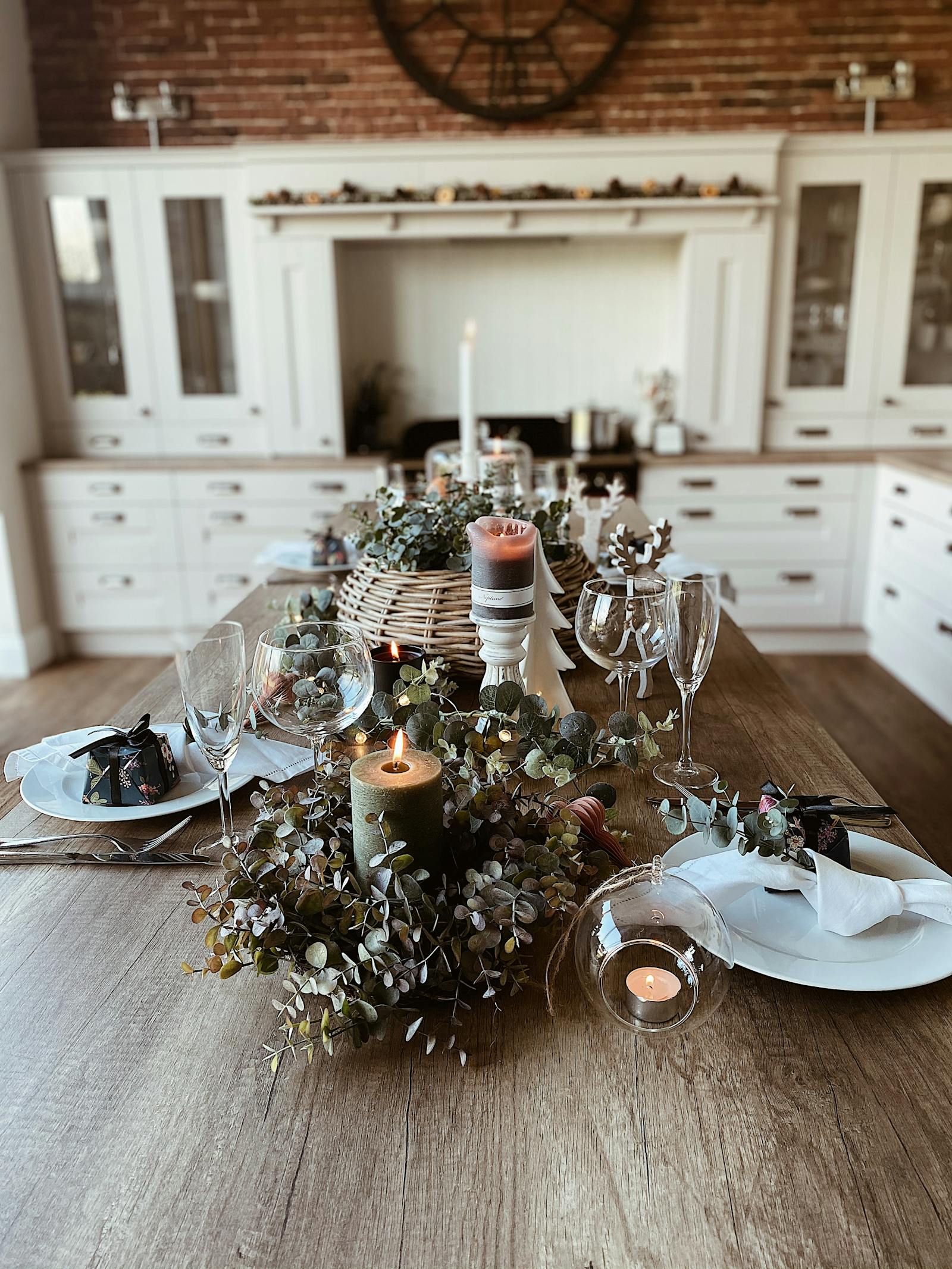 Side view of dining table dressed in fresh eucalyptus foliage