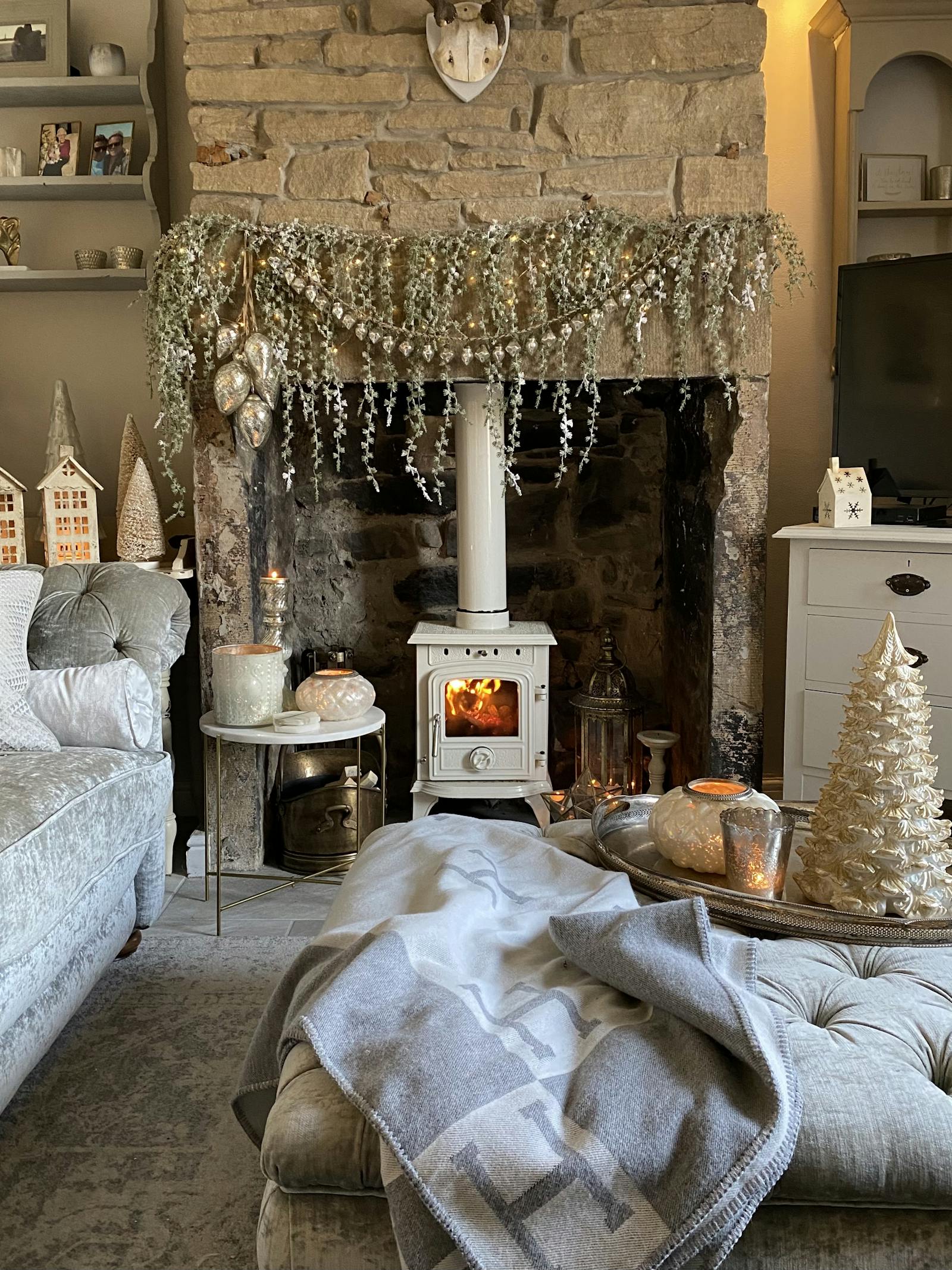 White fireplace surrounded by Christmas decor