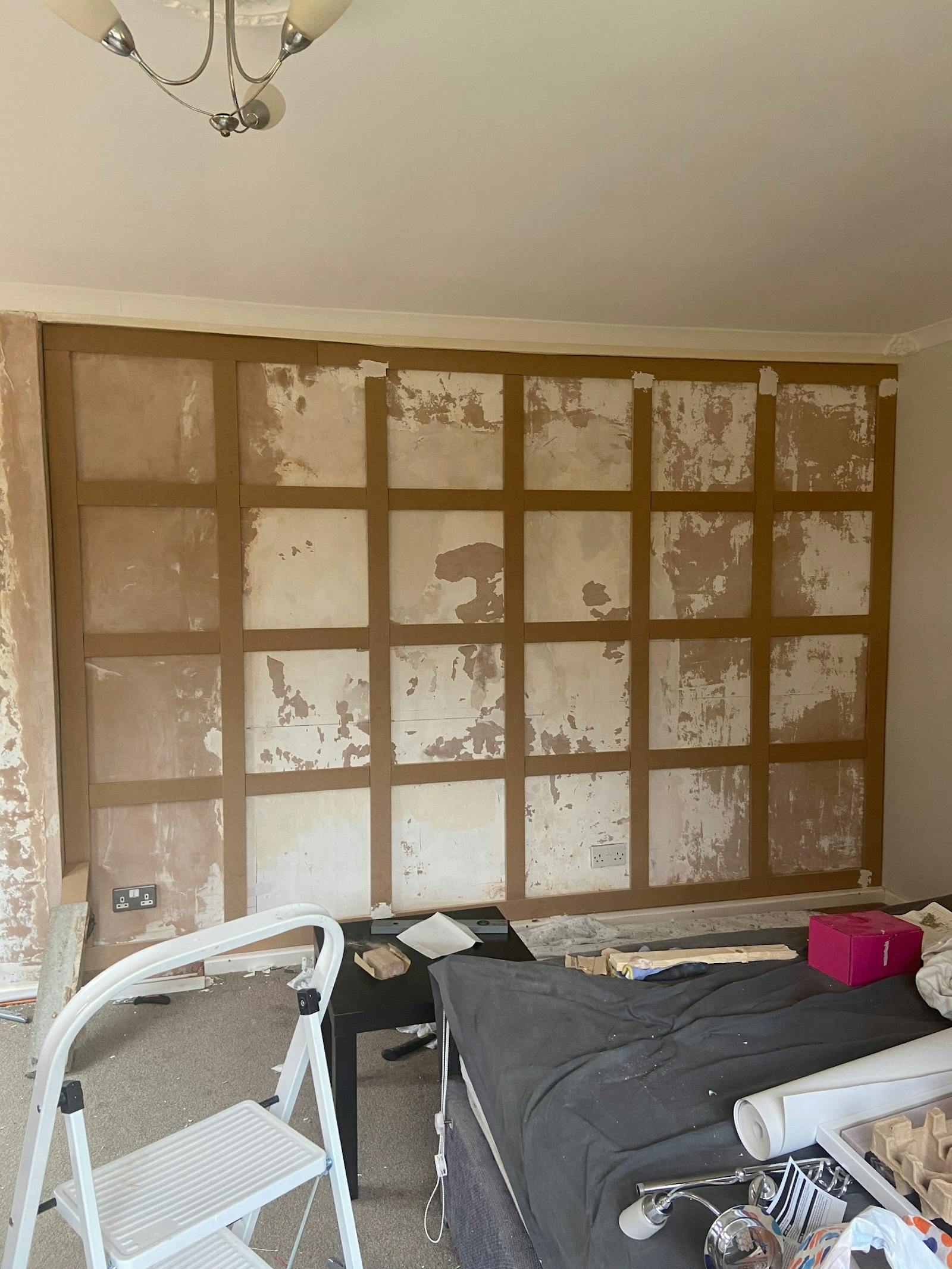 DAOB Before picture of room with peeling plaster and decorating equipment