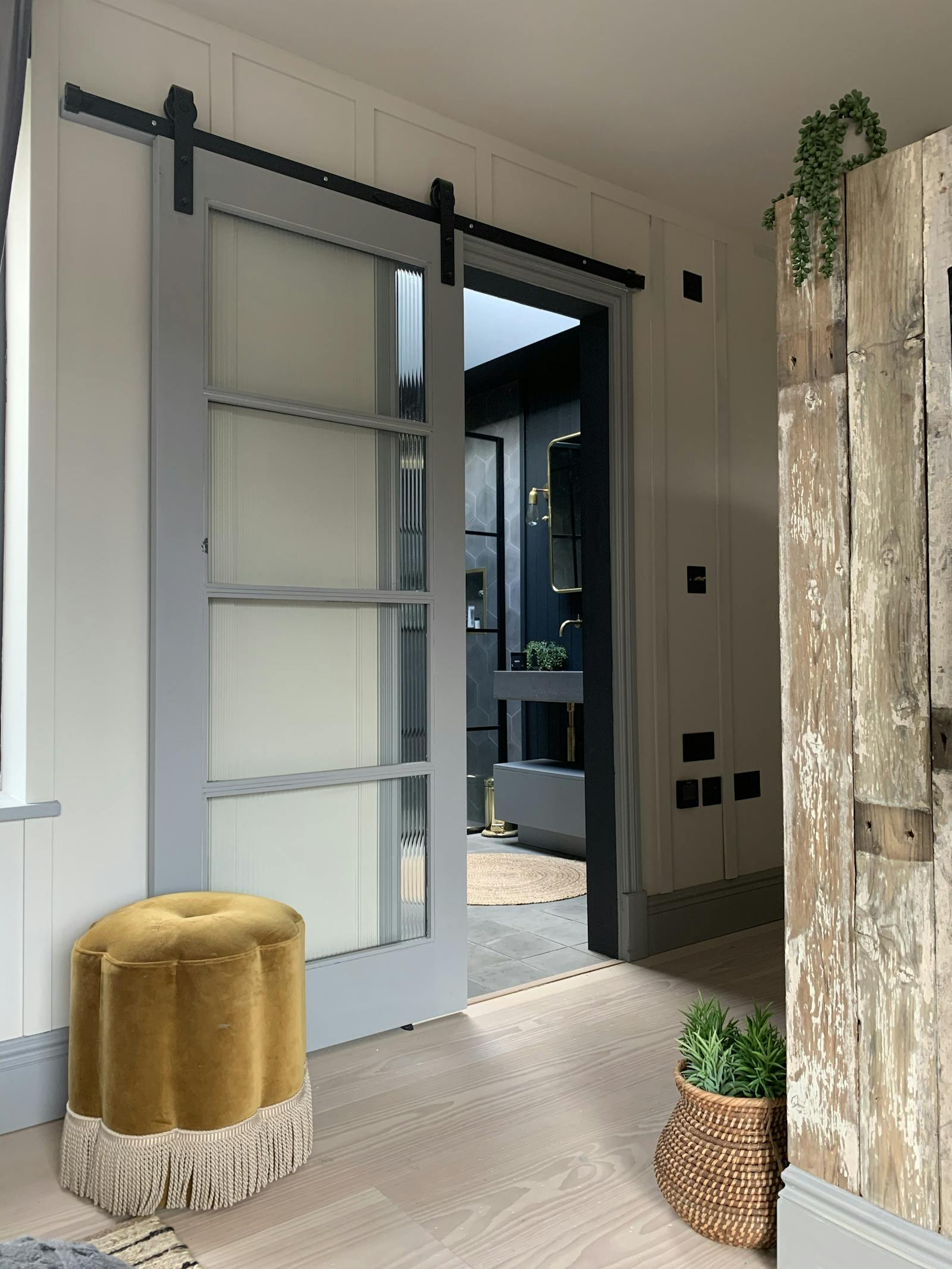 Hallway with natural wood and a velvet chair