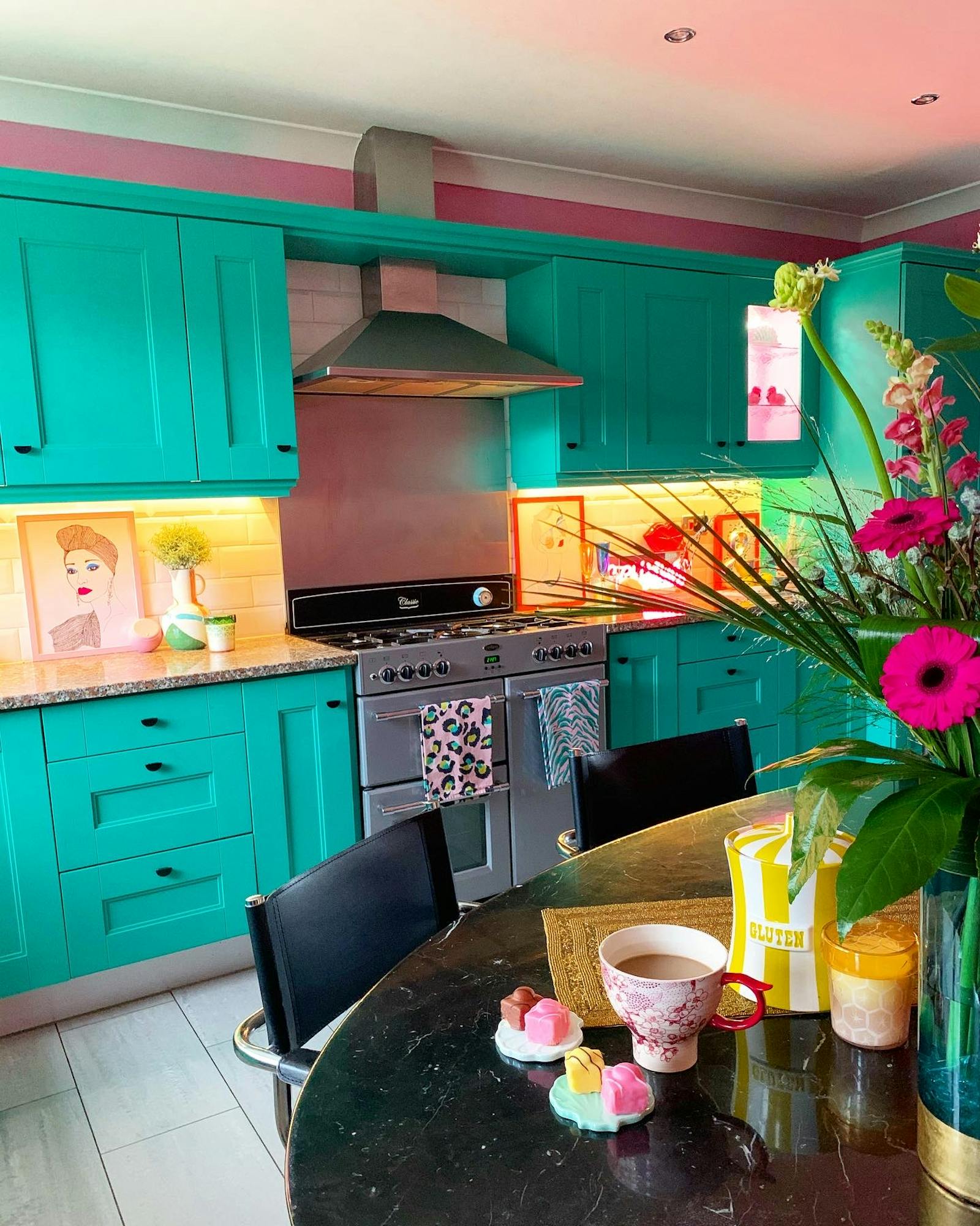 kitchen painted in bright green-blue and pink