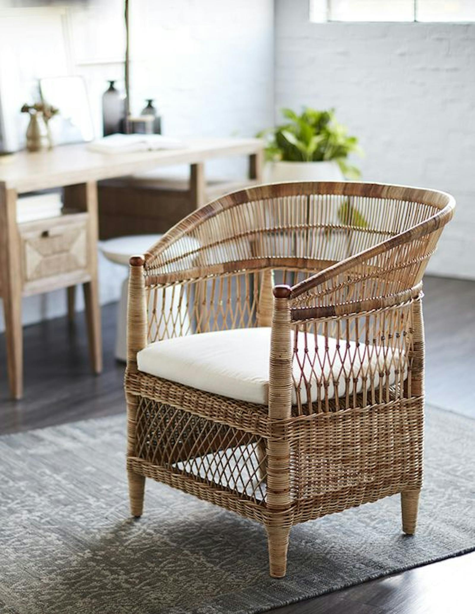 Beautiful rattan Malawian chair in a living room on a grey rug