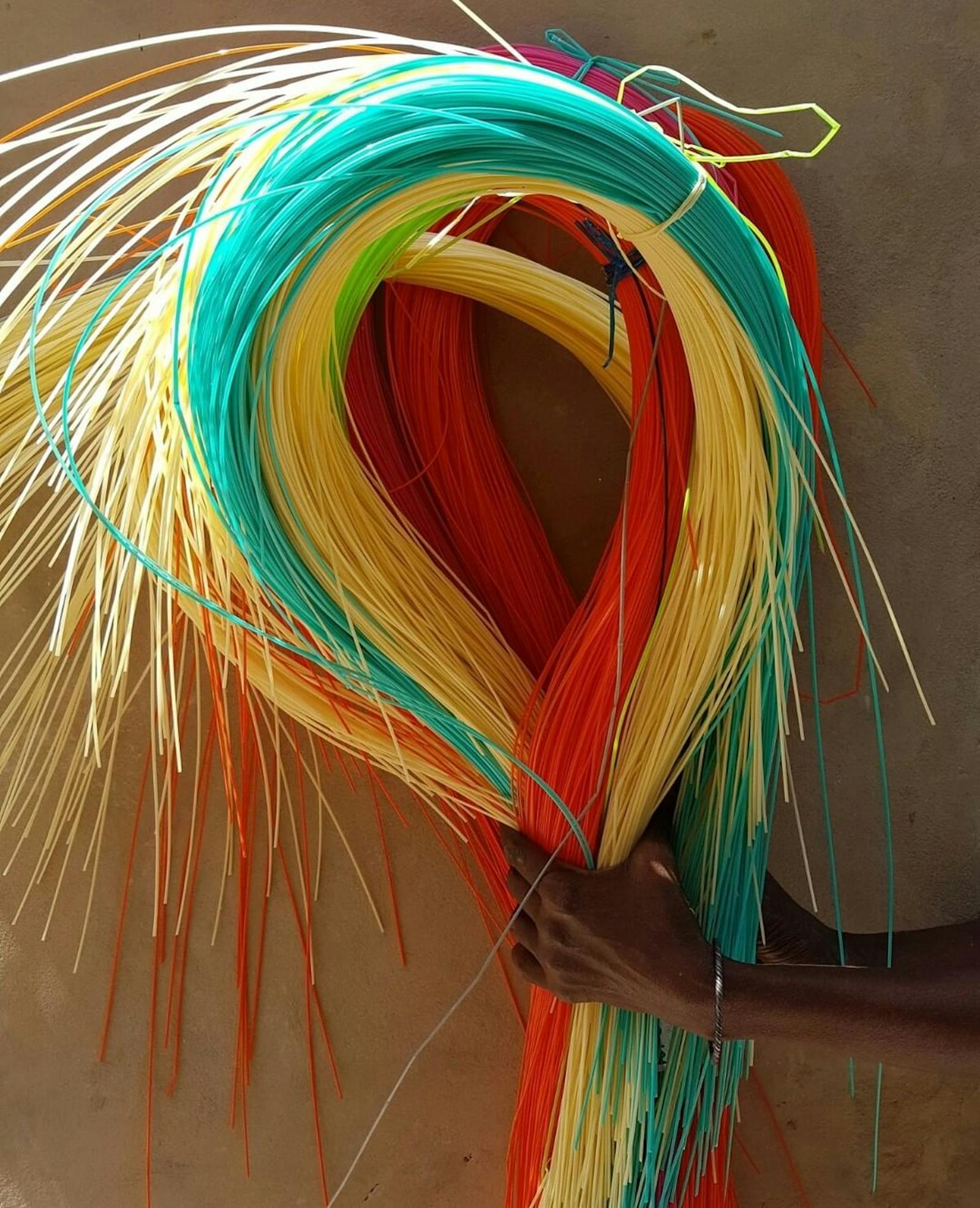 Hand holding raw materials for woven baskets