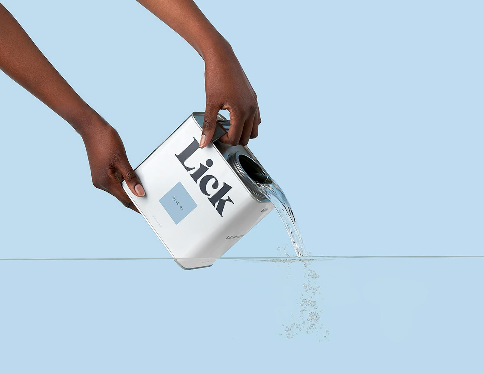 Arms holding a Lick Blue 04 tin and pouring water into water