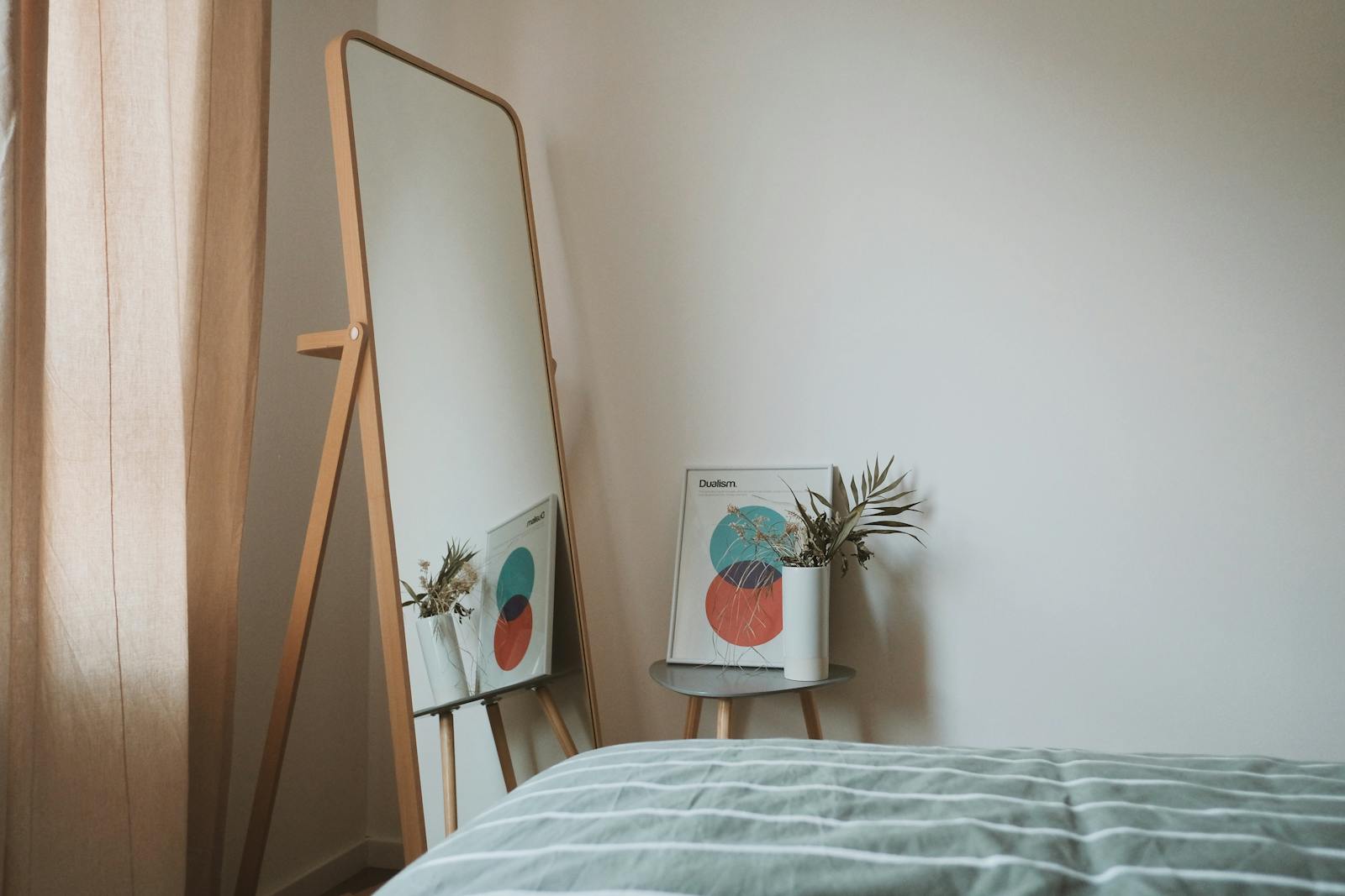 Room with white walls and standing mirror