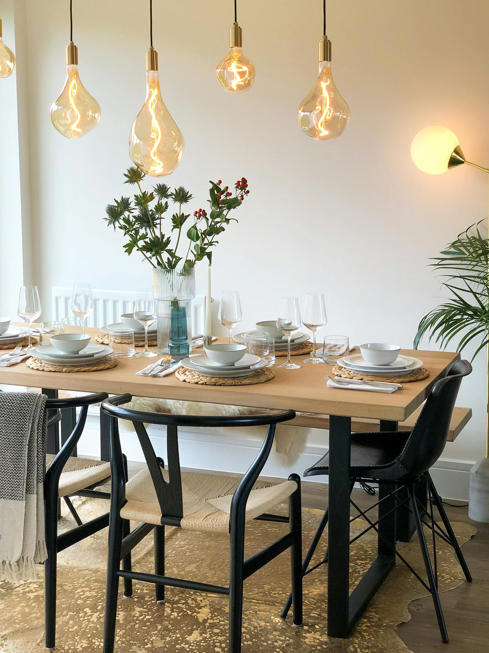 Scandinavian-industrial inspired kitchen with quirky hanging lights and rustic chic furnishing
