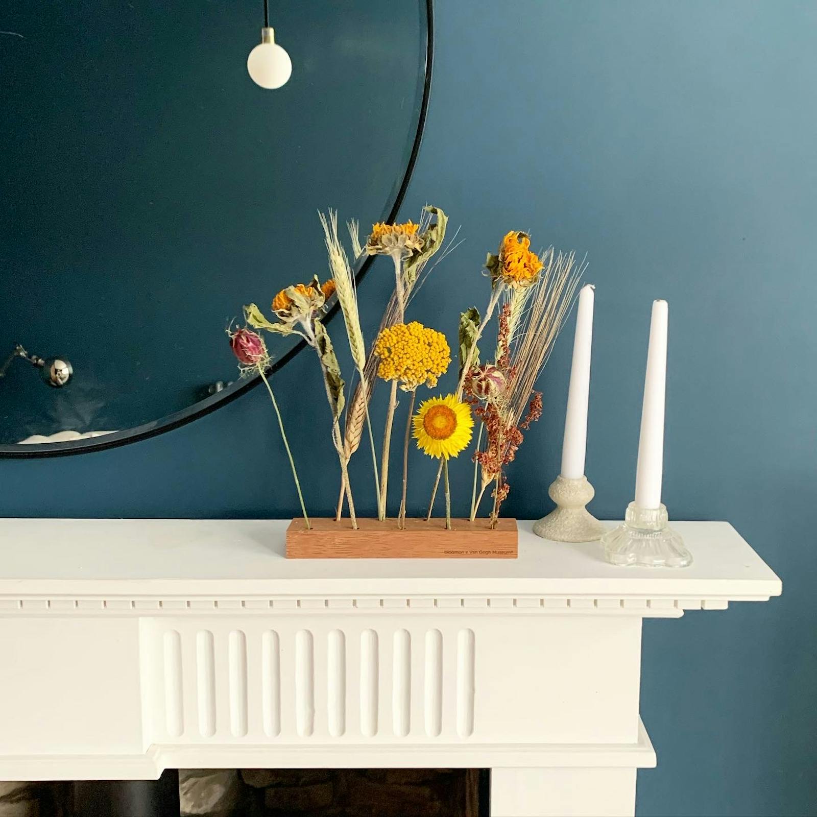 Living room with white fireplace, Lick Blue 07 walls, yellow flowers and candles