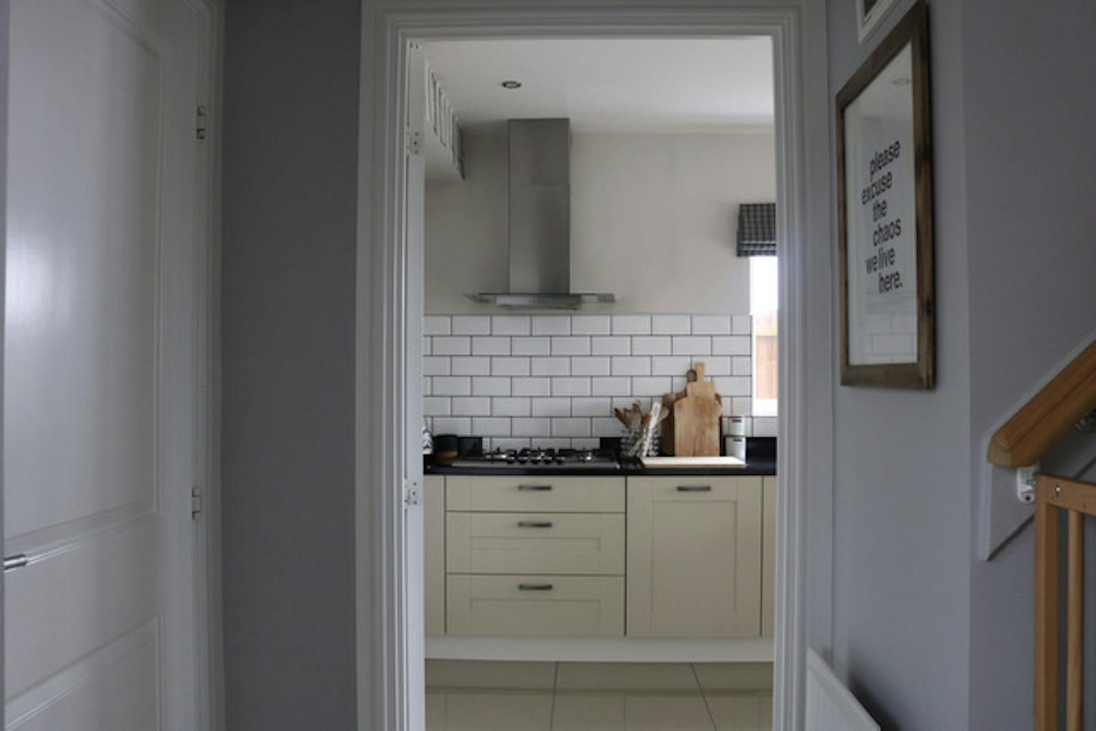 A view of a brightly coloured kitchen through a doorframe