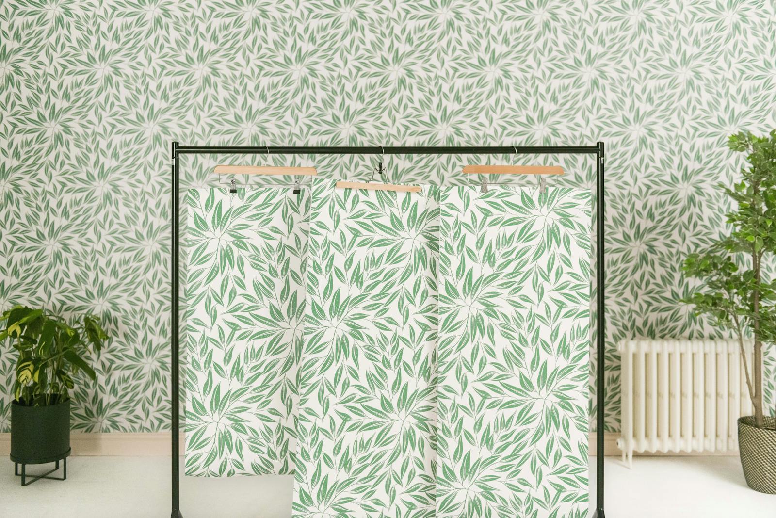 Clothes rail with botanical Lick wallpapers hanging on hangers