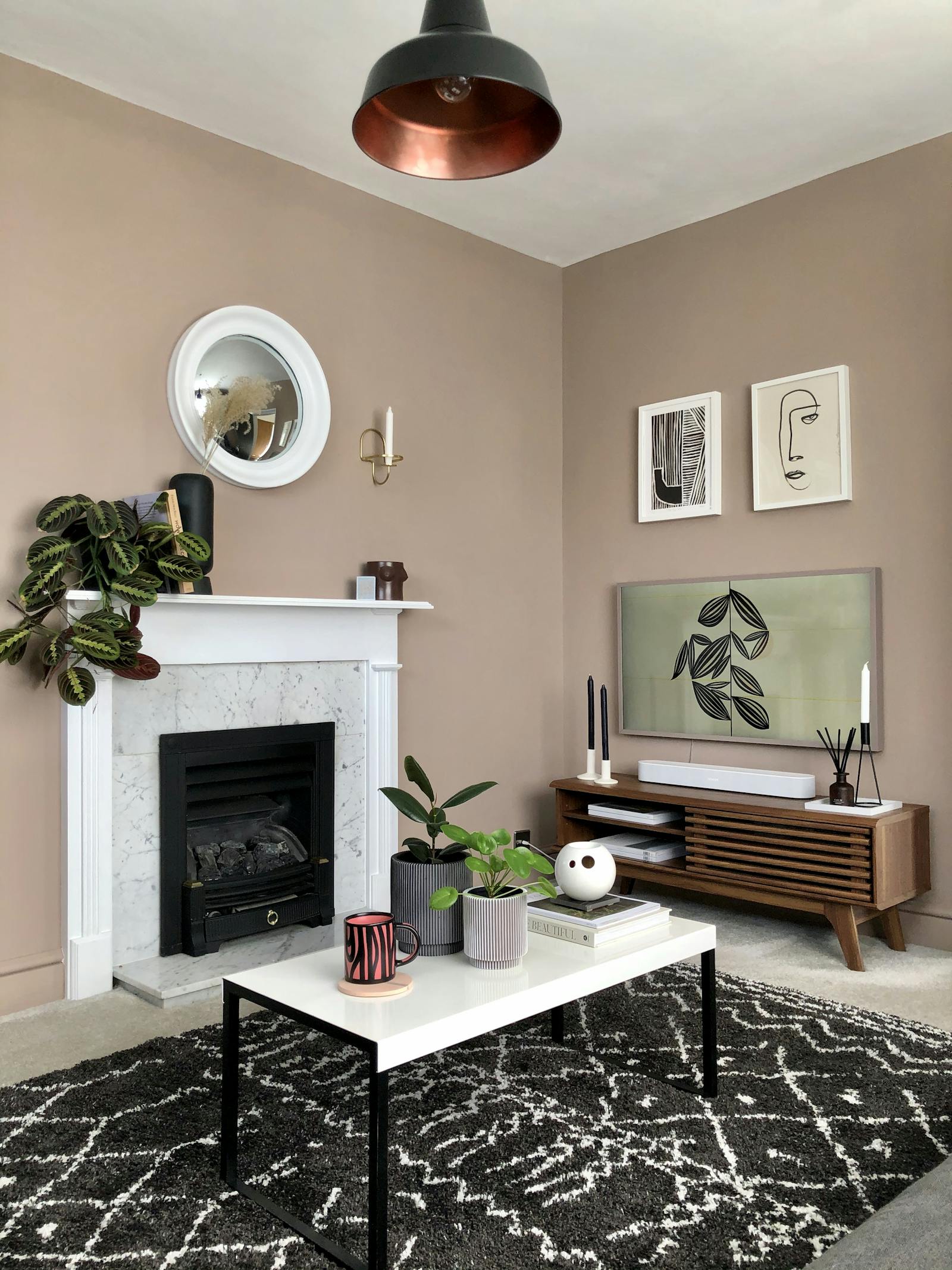 Living room with beige walls and marble fireplace