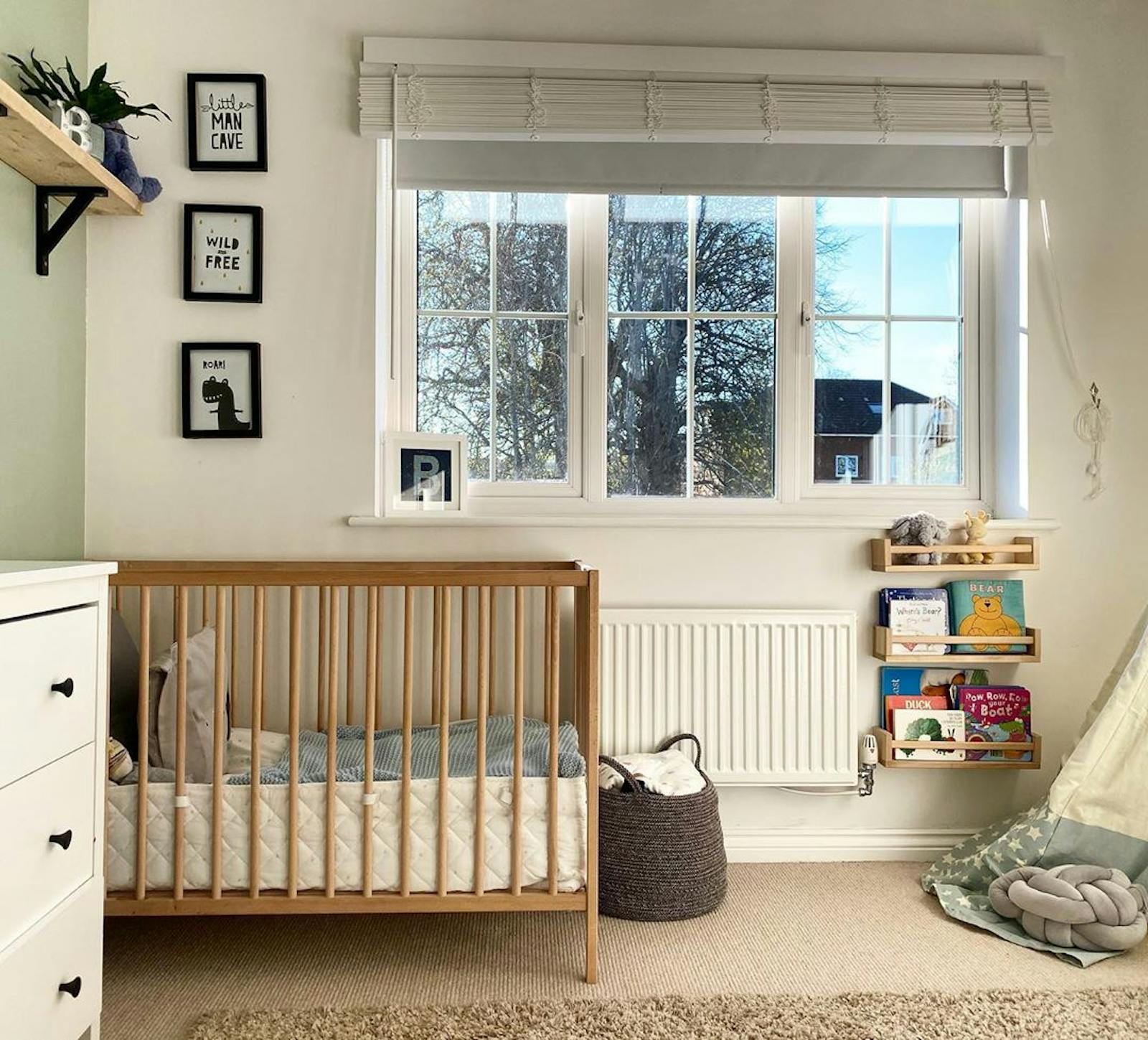 White kids bedroom with black and white artwork and big windows