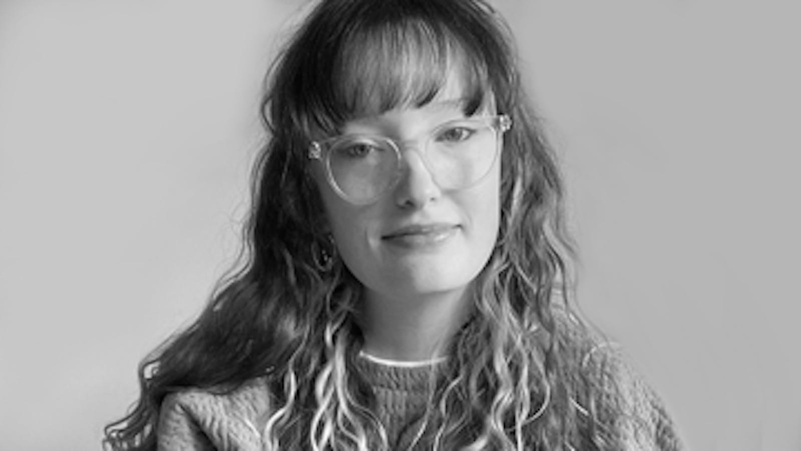 Artist (Franki) smiling in black and white picture