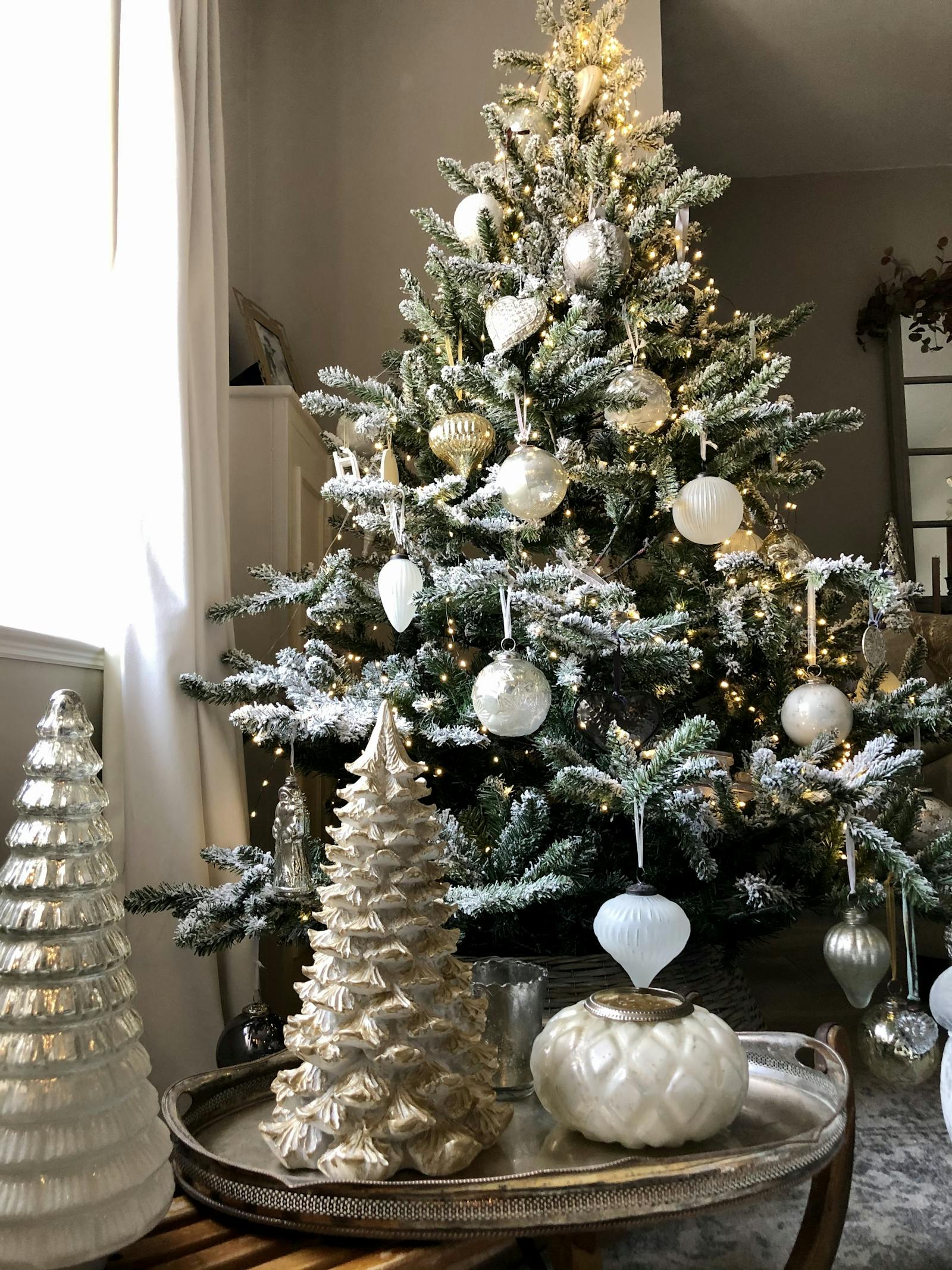 Christmas tree with snow effect and glass baubles in white, gold and ivory