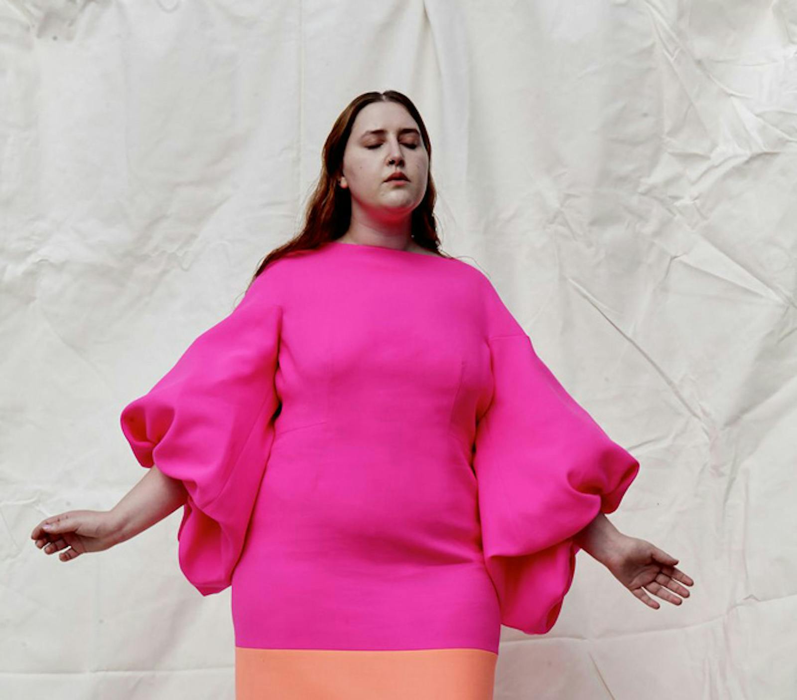 London fashion week shot of woman wearing bold colour blocked pink and salmon dress