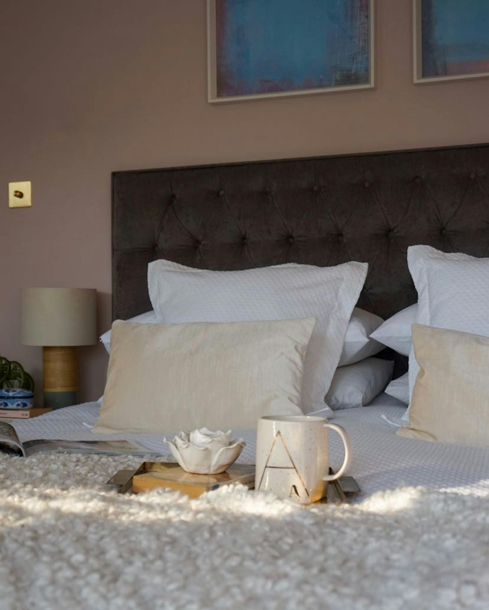 Close up of a big bed with some decoration on the blanket
