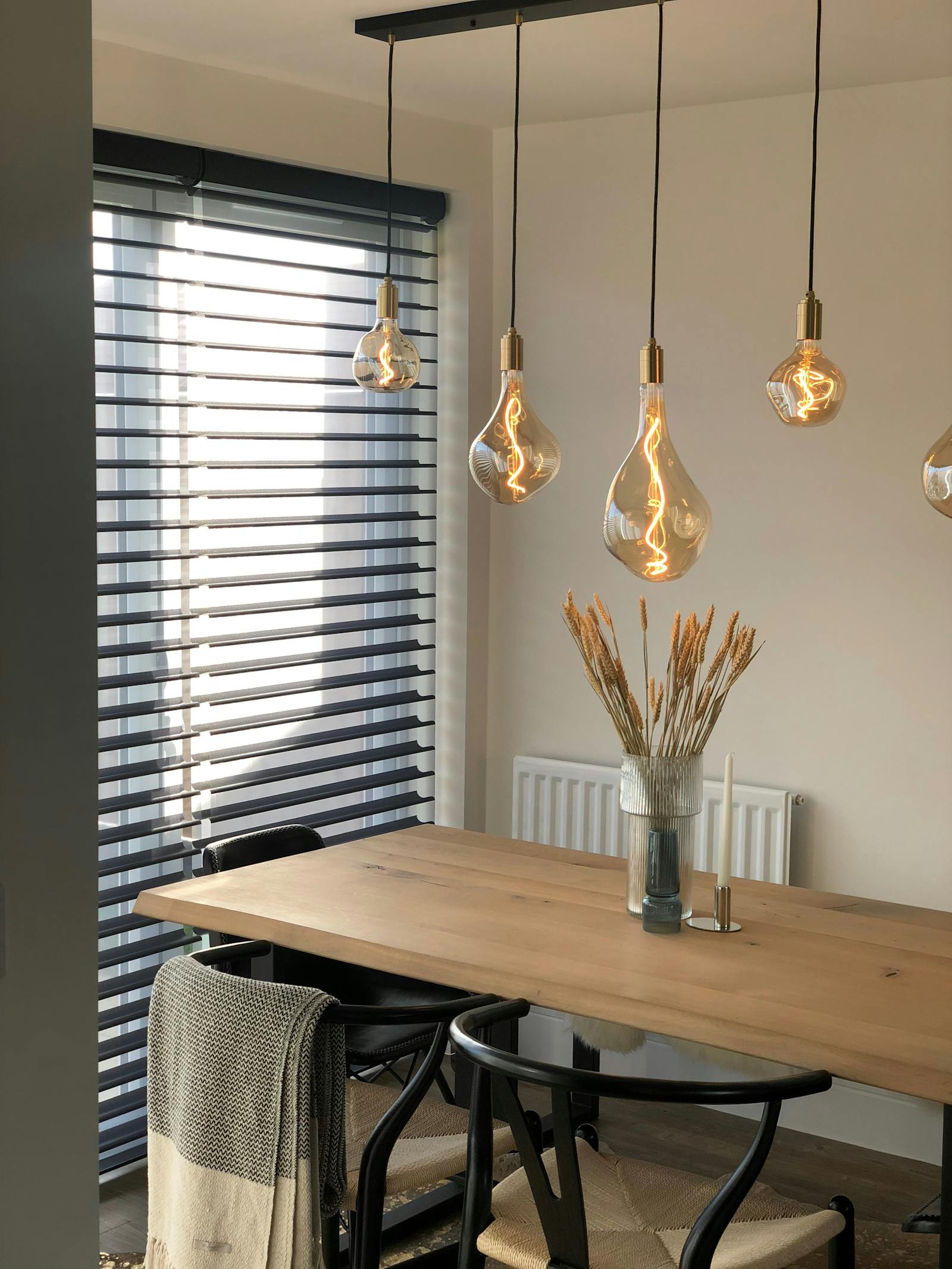 Scandinavian-industrial inspired kitchen with quirky hanging lights and rustic chic furnishing