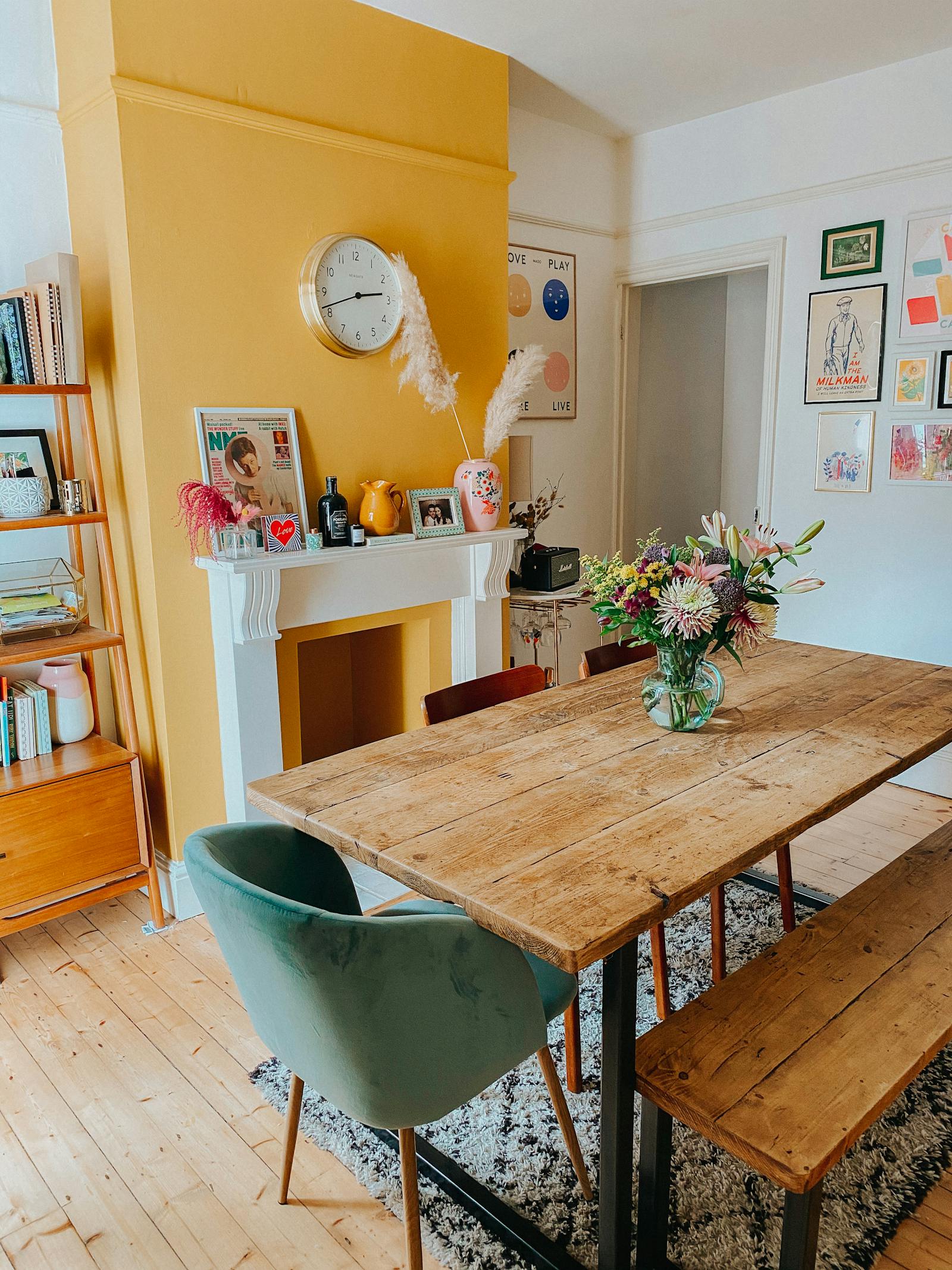 A brightly yellow painted fireplace oozing character and happiness