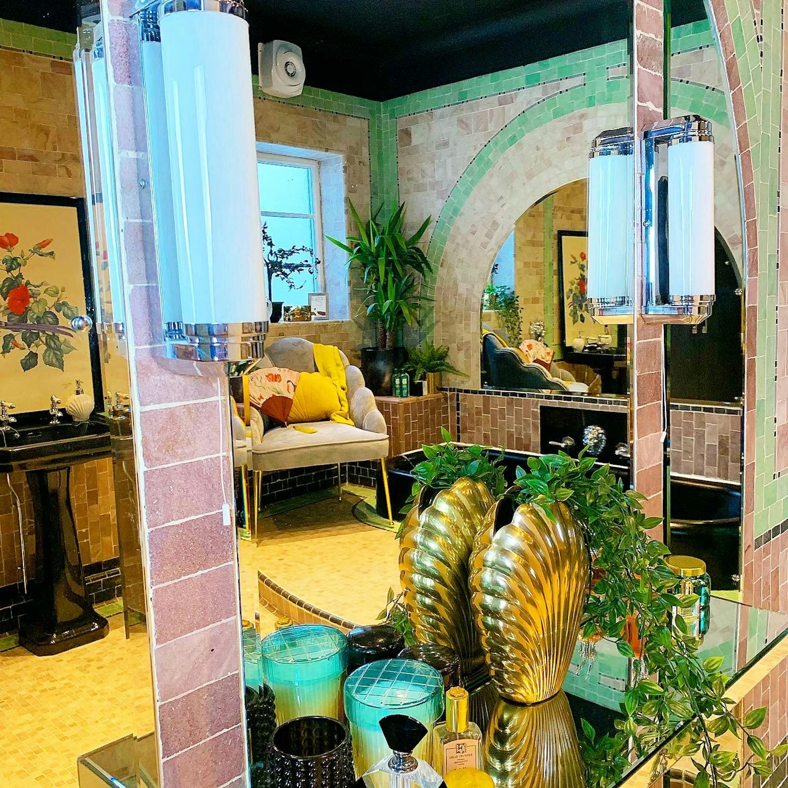 an eclectic bathroom full of different tiles and designs