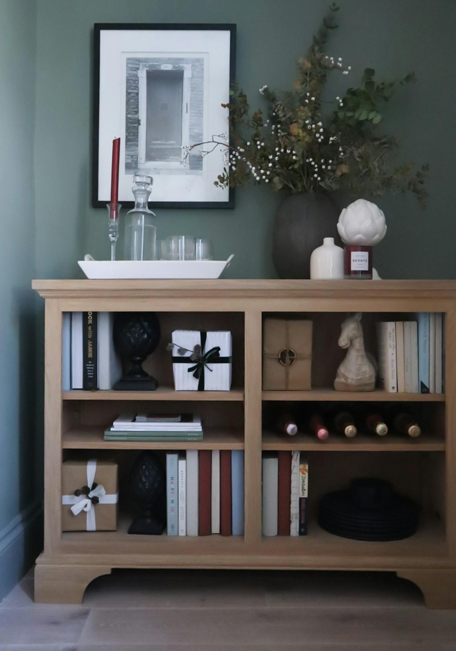 Display bookcase with Christmas presents and candle decorations