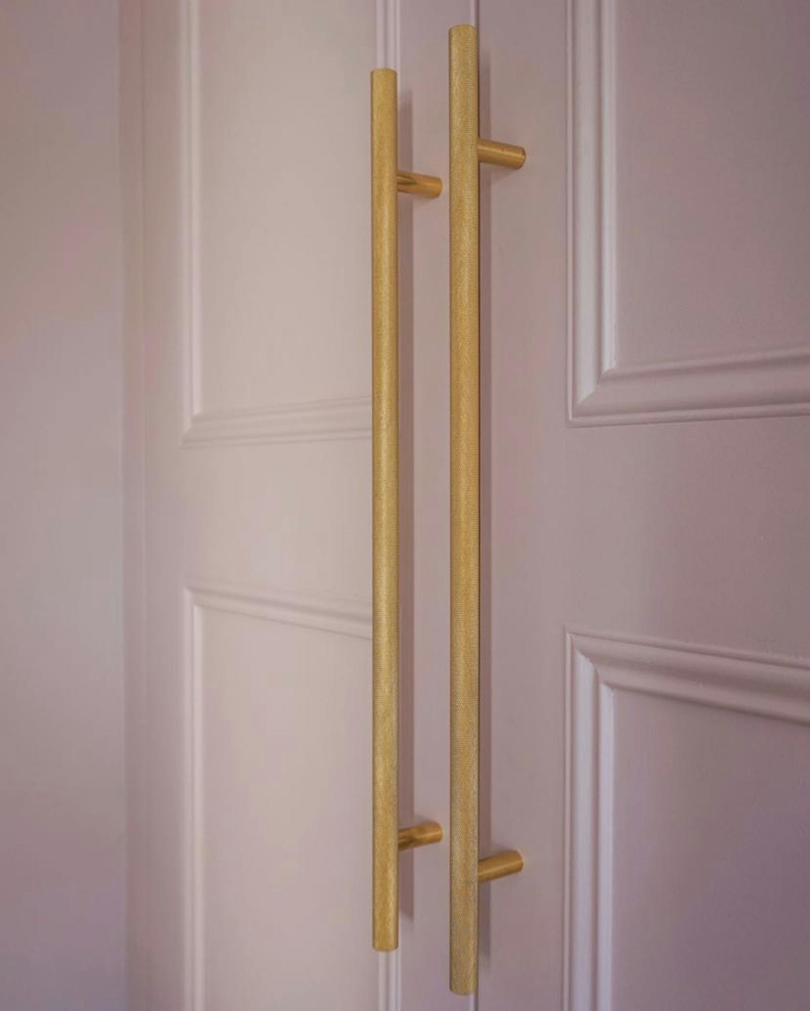 Pink doors with large wooden handles