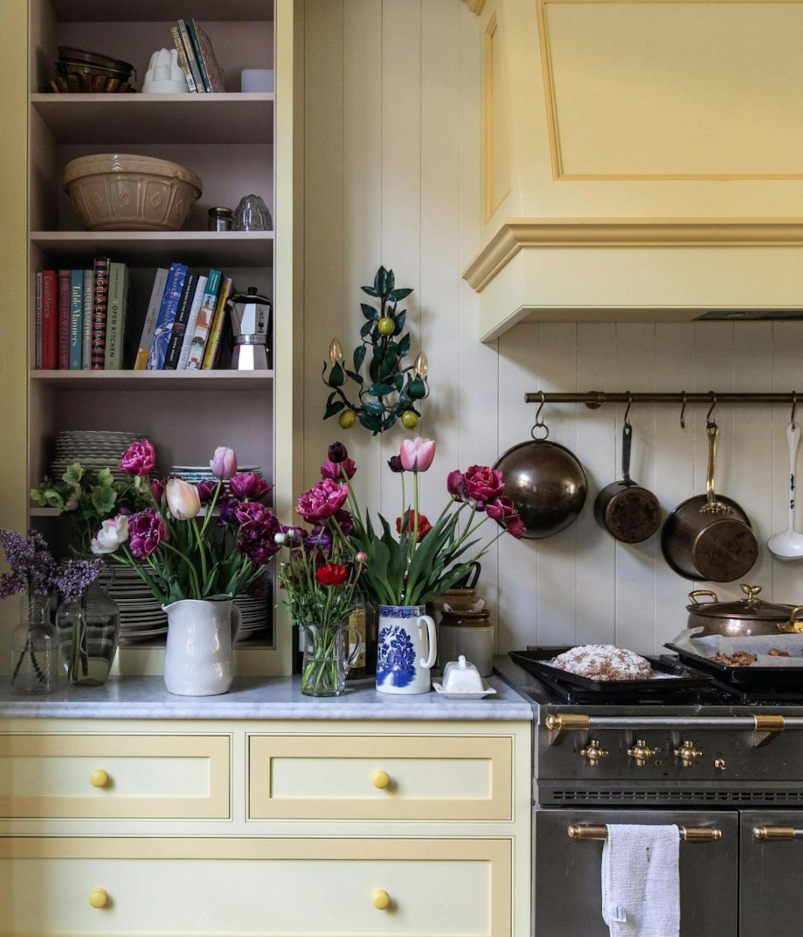 Kitchen with yellow cabinets and pink flowers