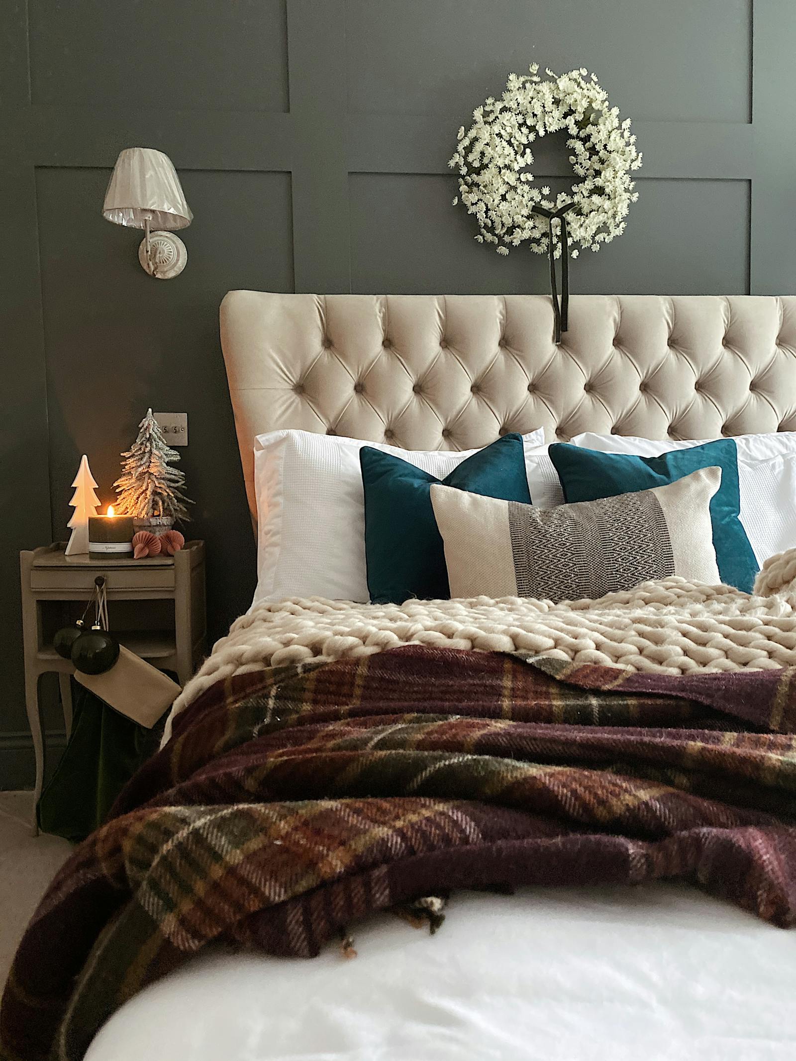 Double bed against a grey panelled wall