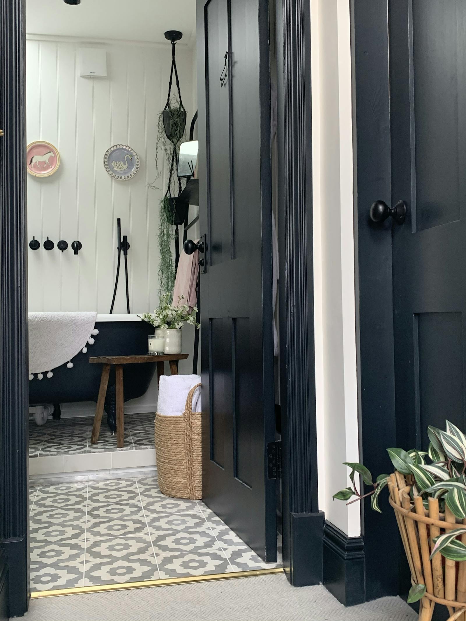 Hallway with an open door leading to a bathroom