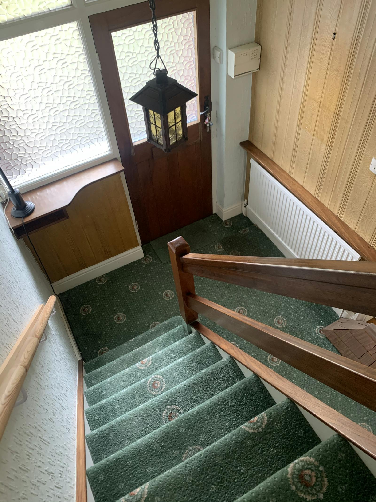 Image of dated green carpet running down stairs.