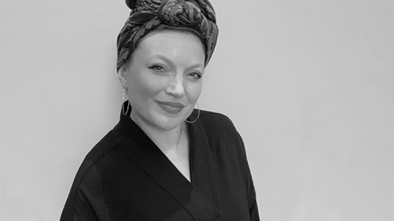 Artist (Annika) smiling in black and white picture