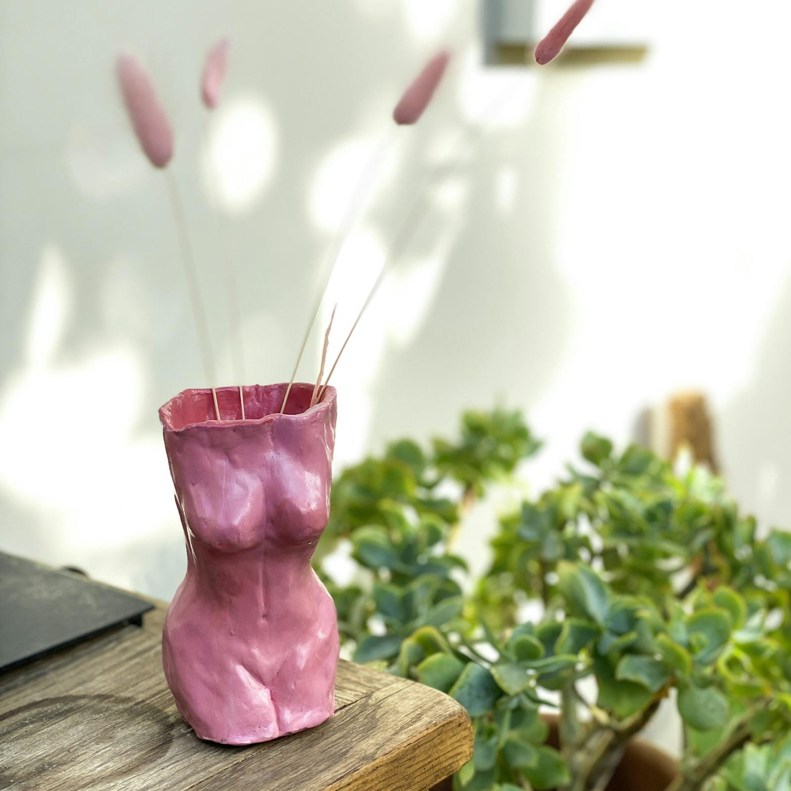 Female shaped vase with pink pampas