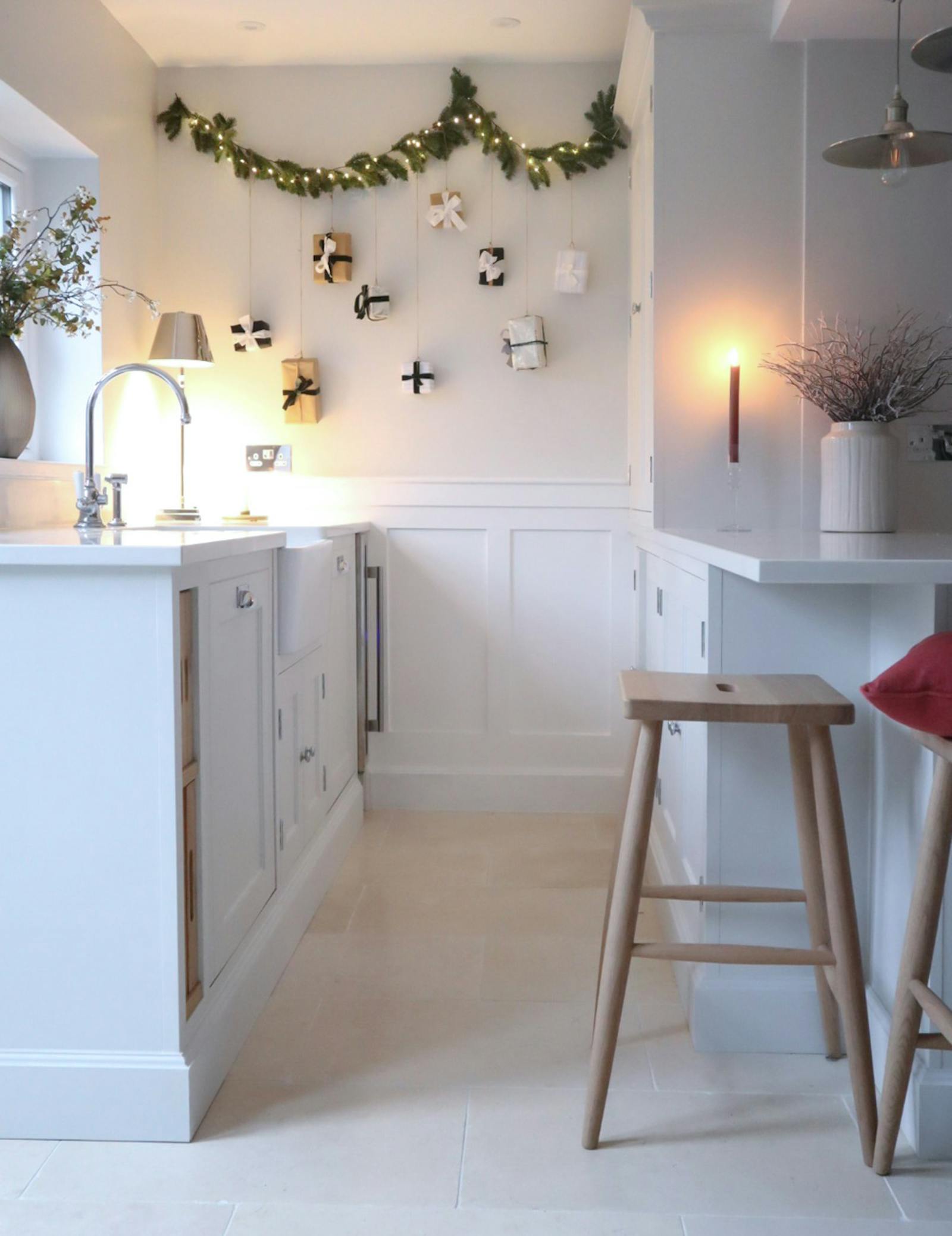 Kitchen decorated in Christmas garlands, presents and lights