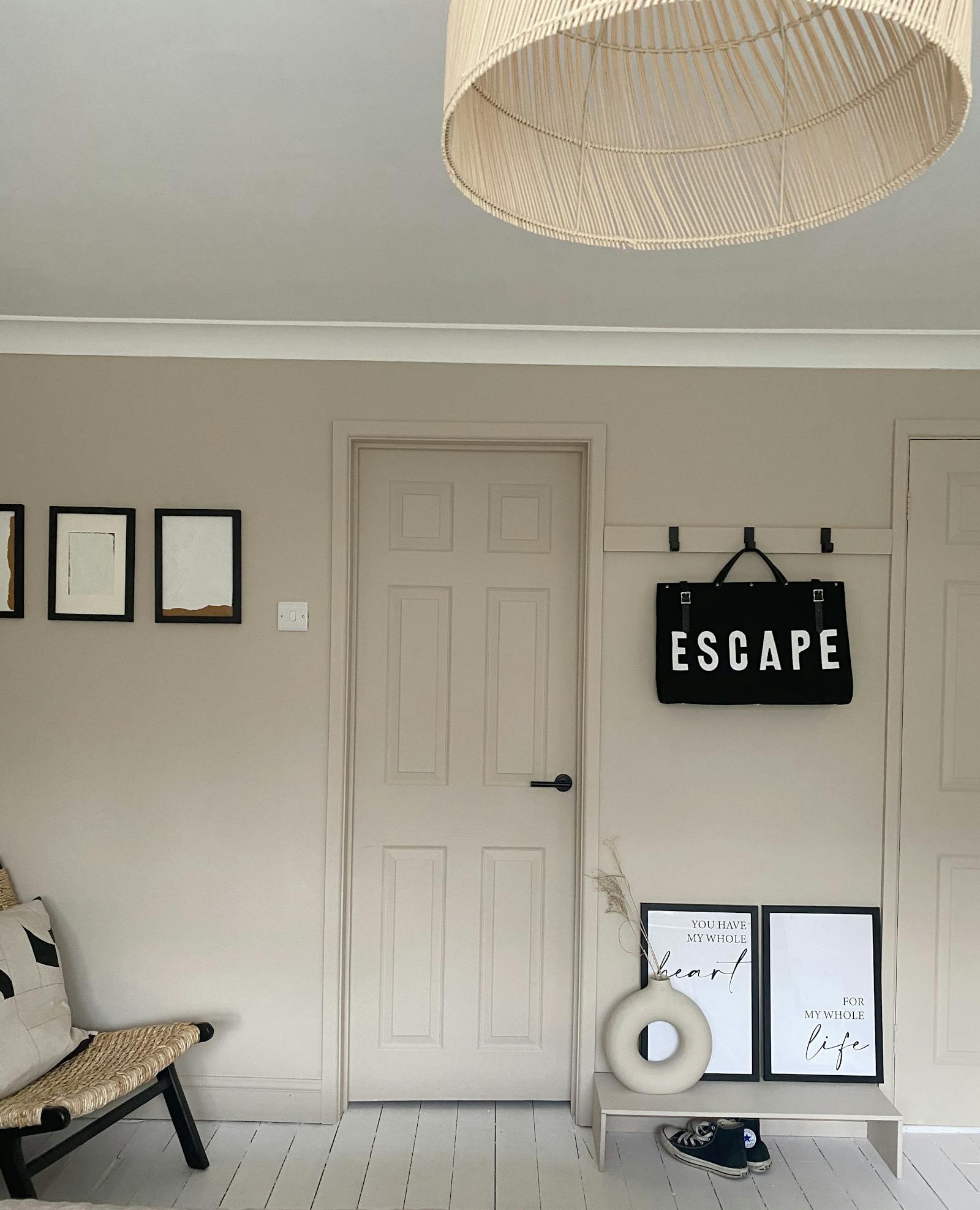 Hallway in greige colour with matching details and artwork