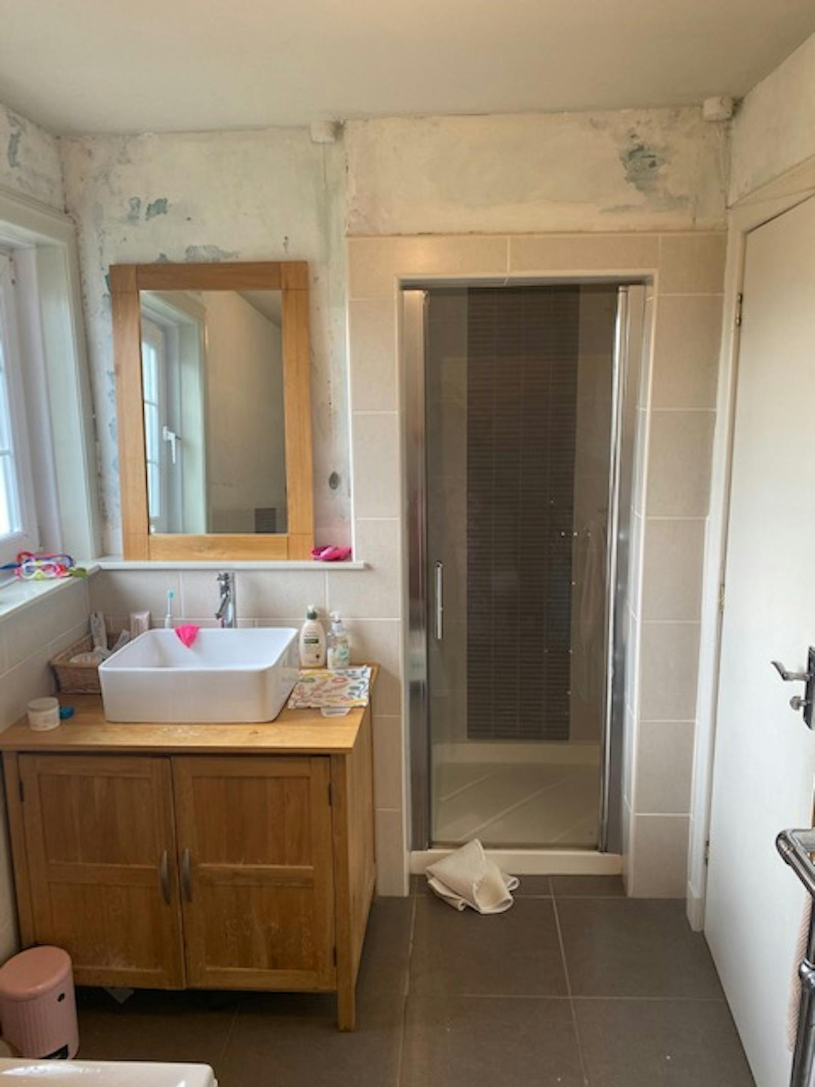 Beige shower with wooden cabinets