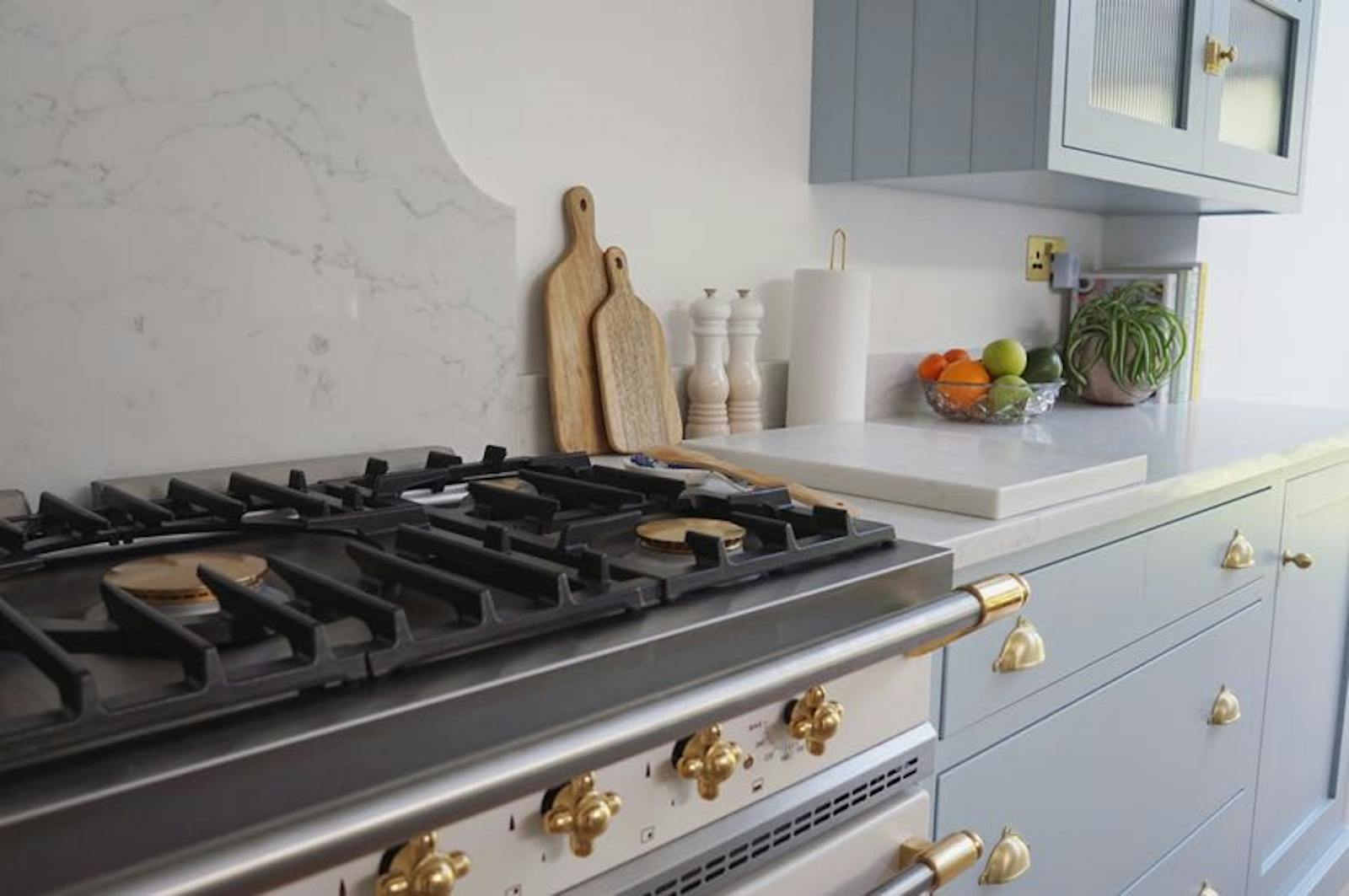 Close up of a light blue kitchen and a stove