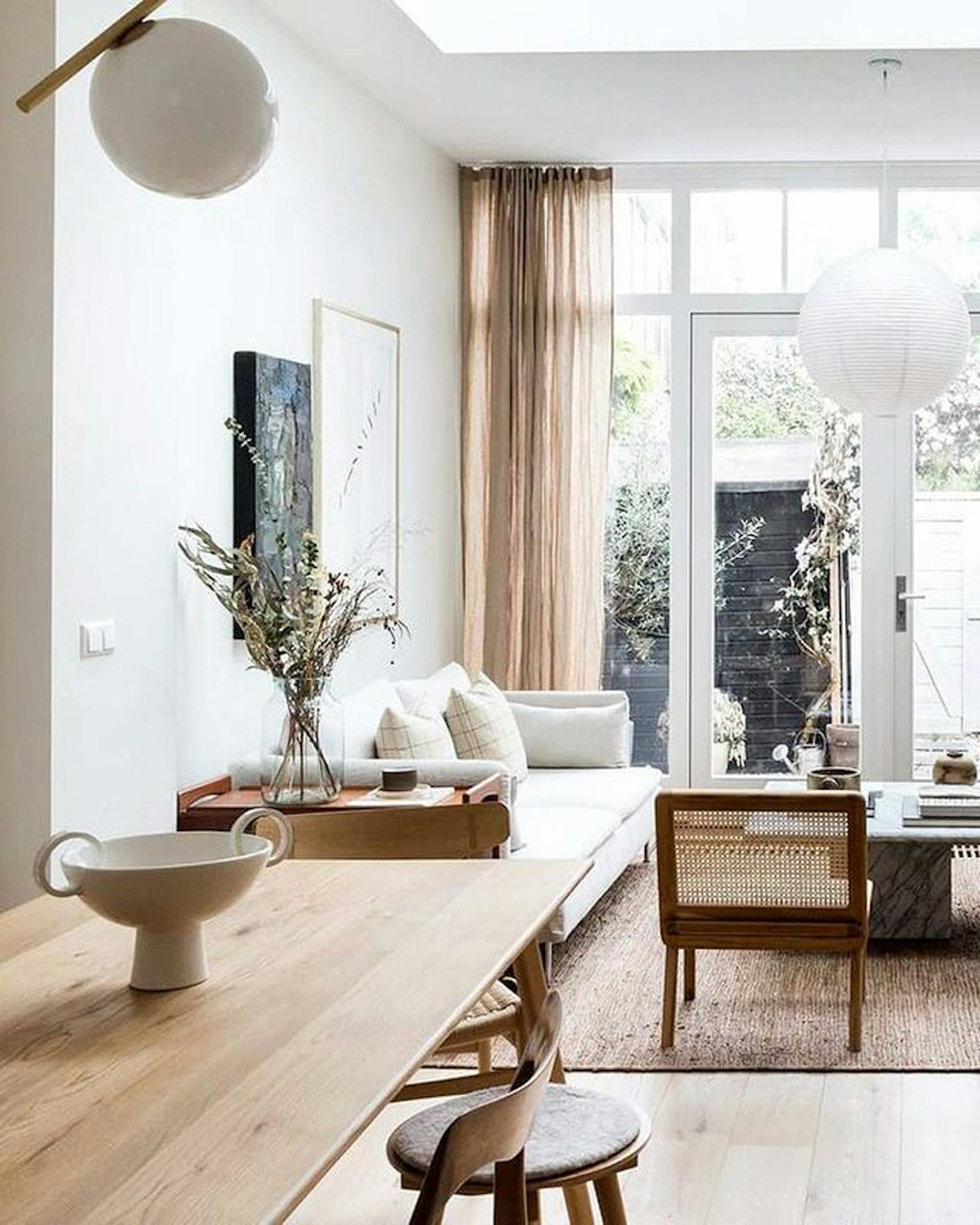 Open-plan kitchen living room decorated in neutral colours, in a Japandi interior style