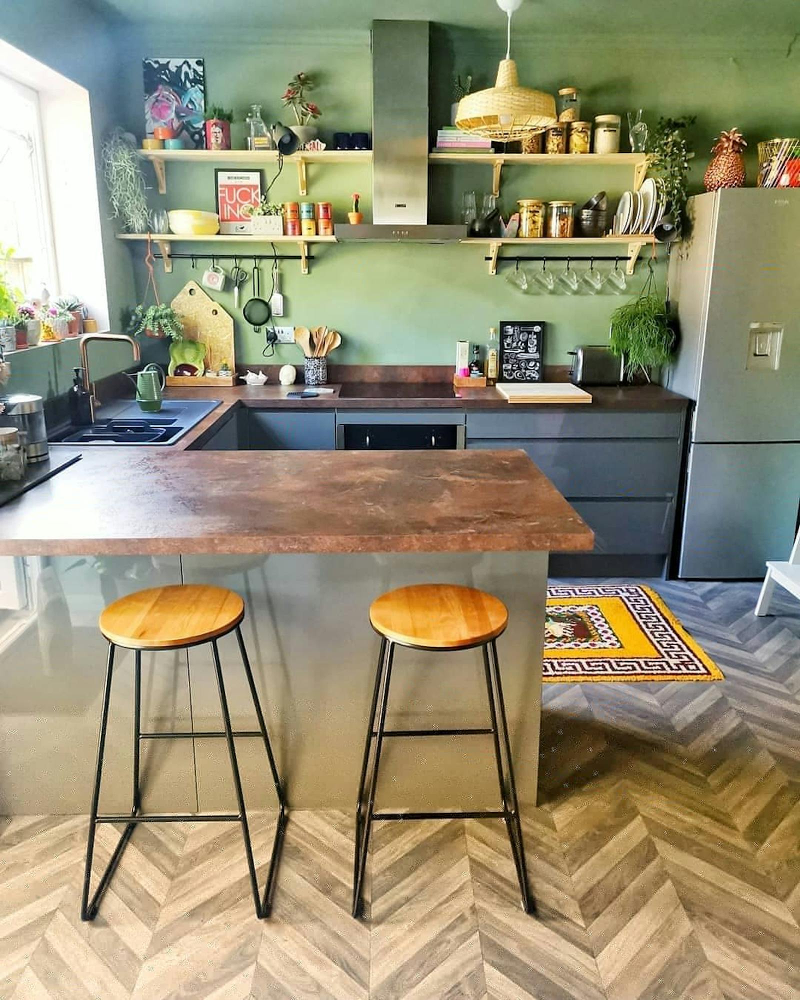 Kitchen painted in light green with wooden and vintage details