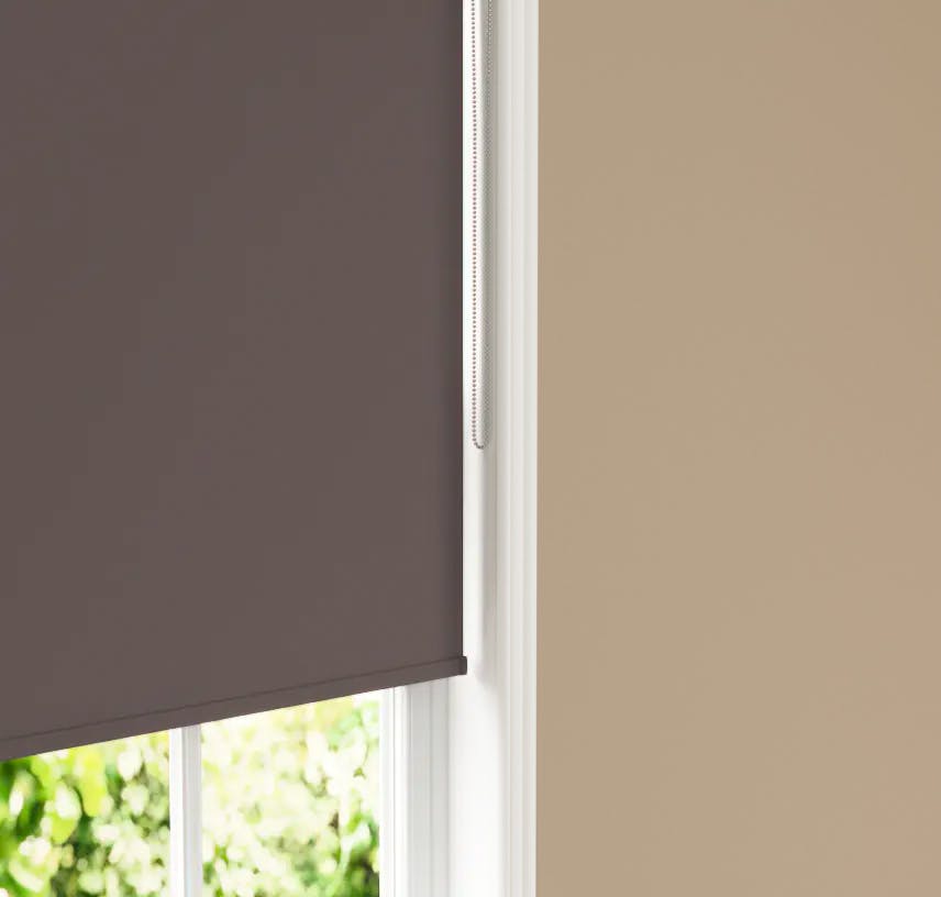 Close up of Lick Brown 01 roller blind against Beige 02 wall