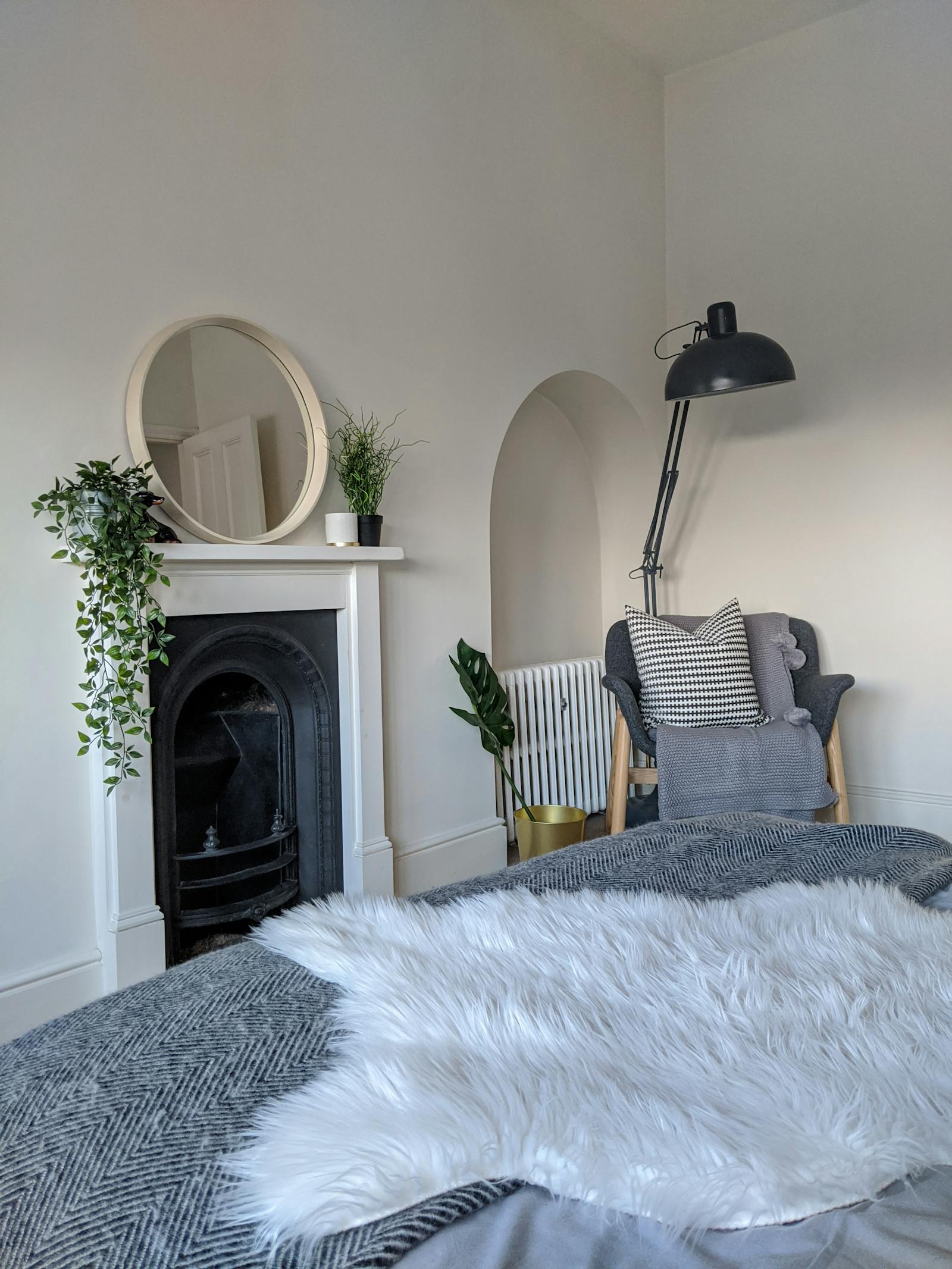 Bedroom with white walls and a fireplace