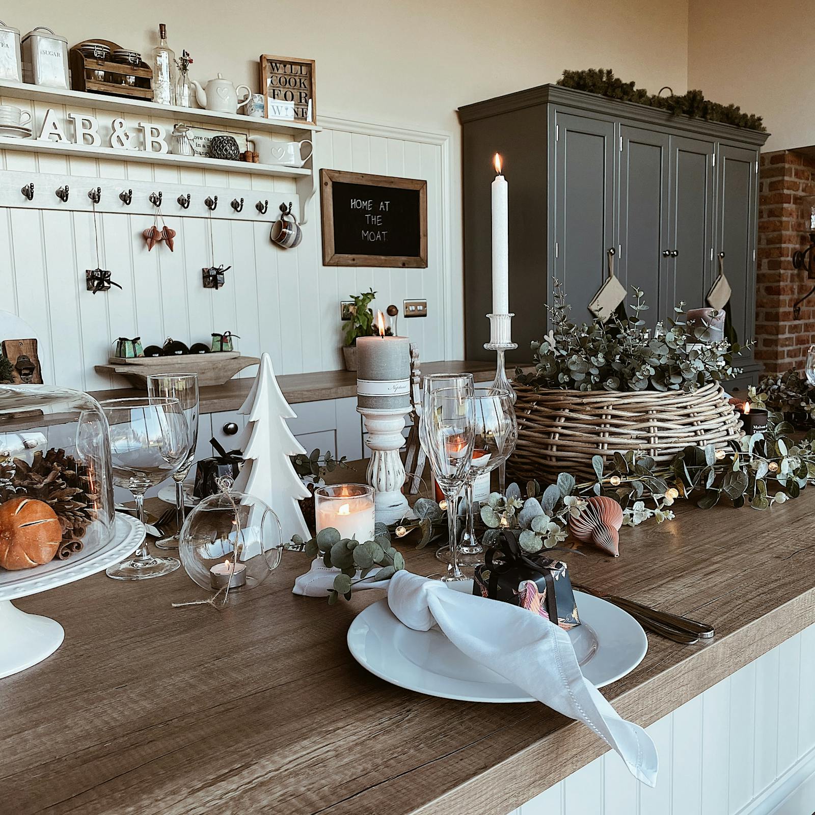 A dining table with fresh eucalyptus as table scape