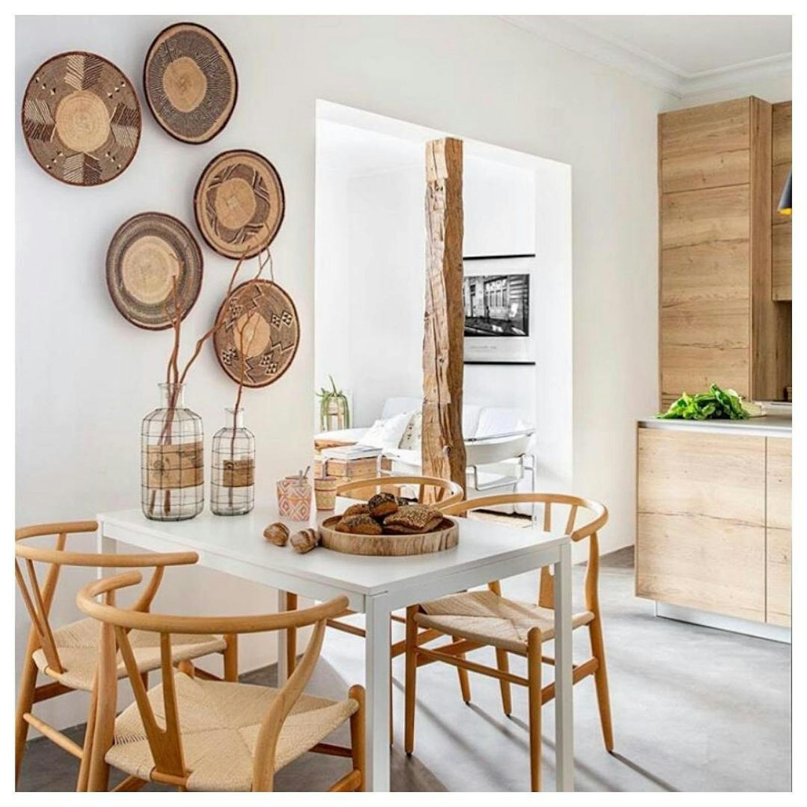 Kitchen & dining room area decorated in rattan chairs and wall decor