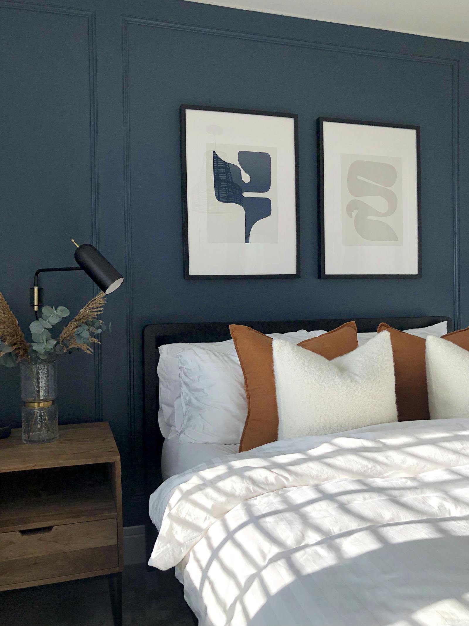 Scandinavian inspired bedroom with dark blue wall panelling