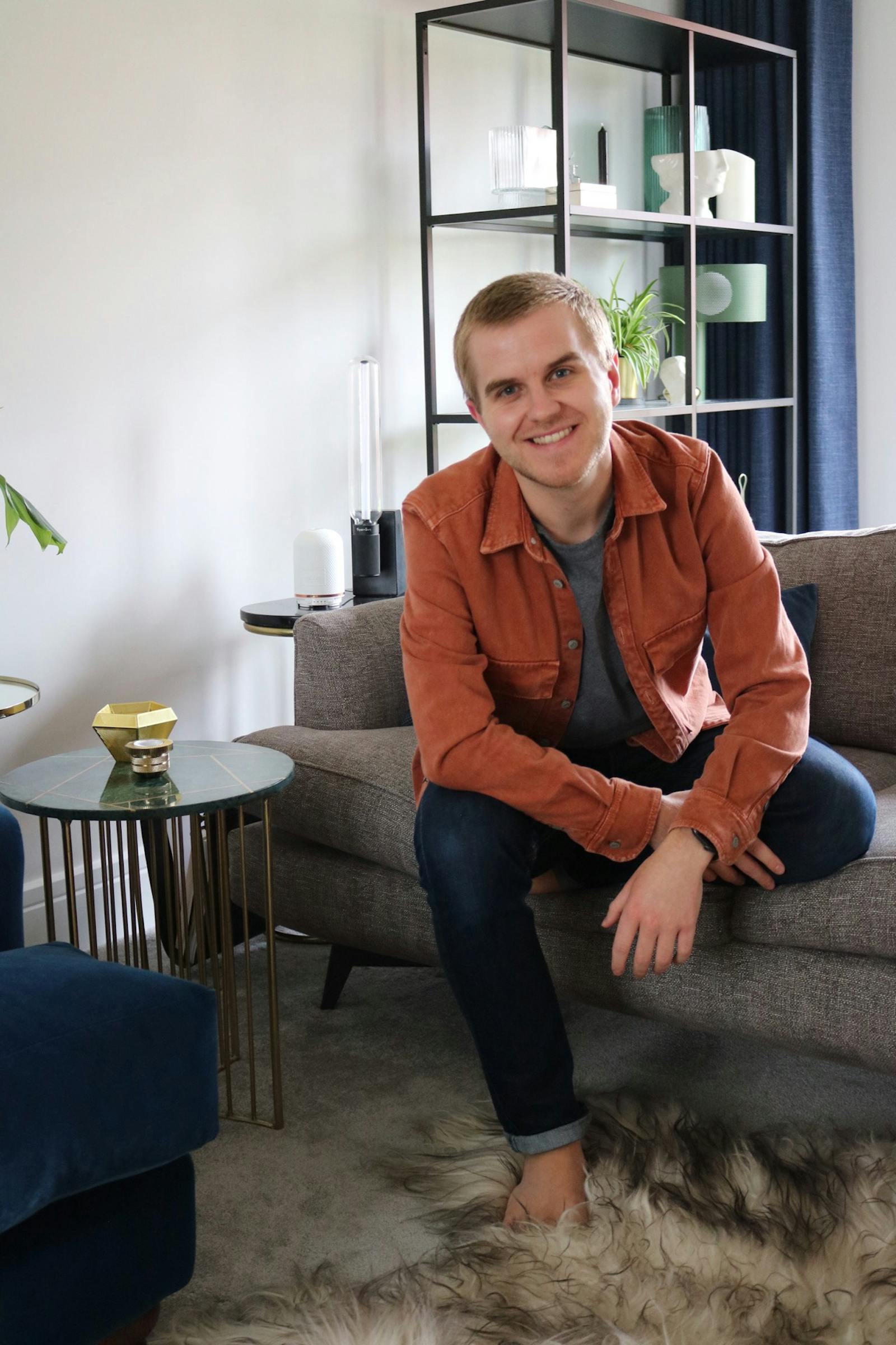 Portrait of man sitting of sofa smiling
