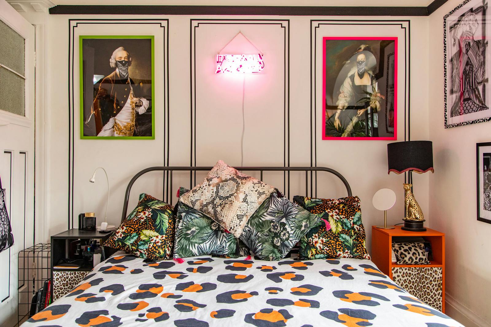 RHOI bedroom with neon light and animal print bed covers and side tables