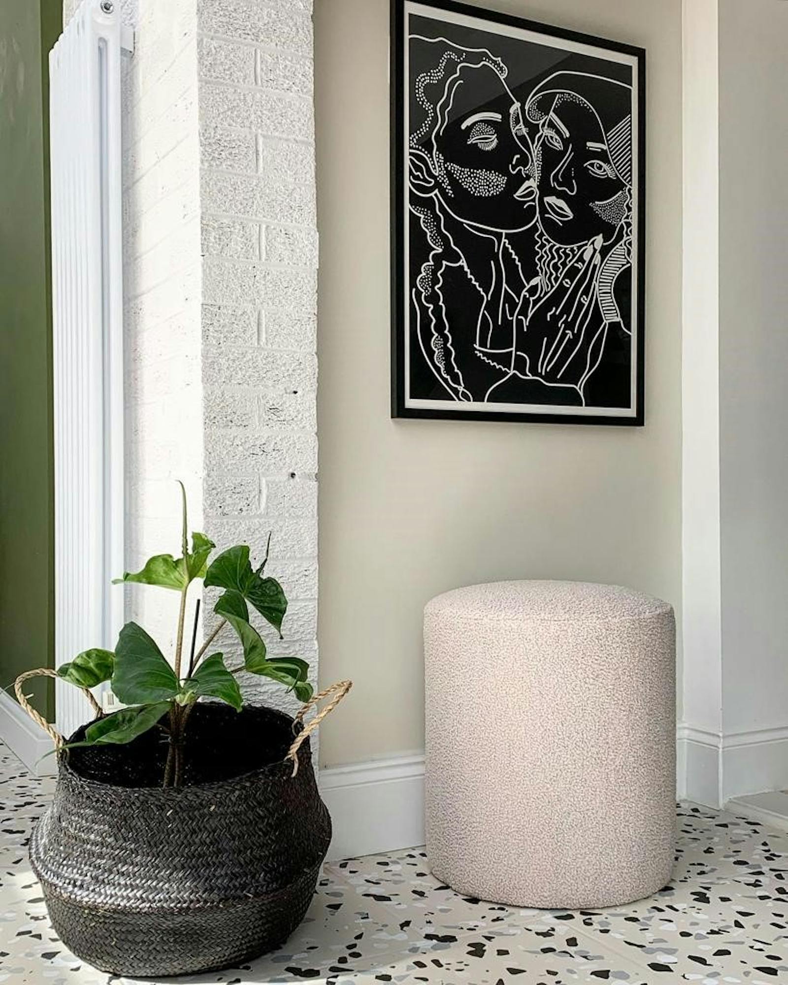 Hallway with black artwork and an exposed brick wall