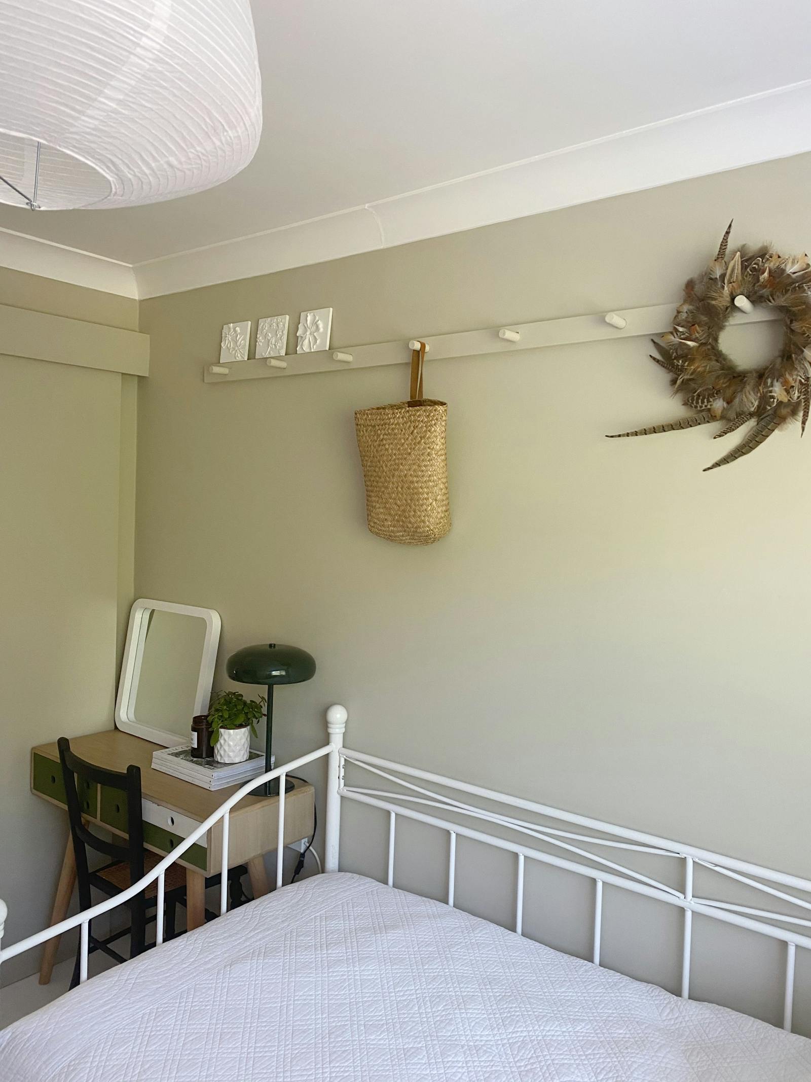 Spare bedroom painted in a light green colour