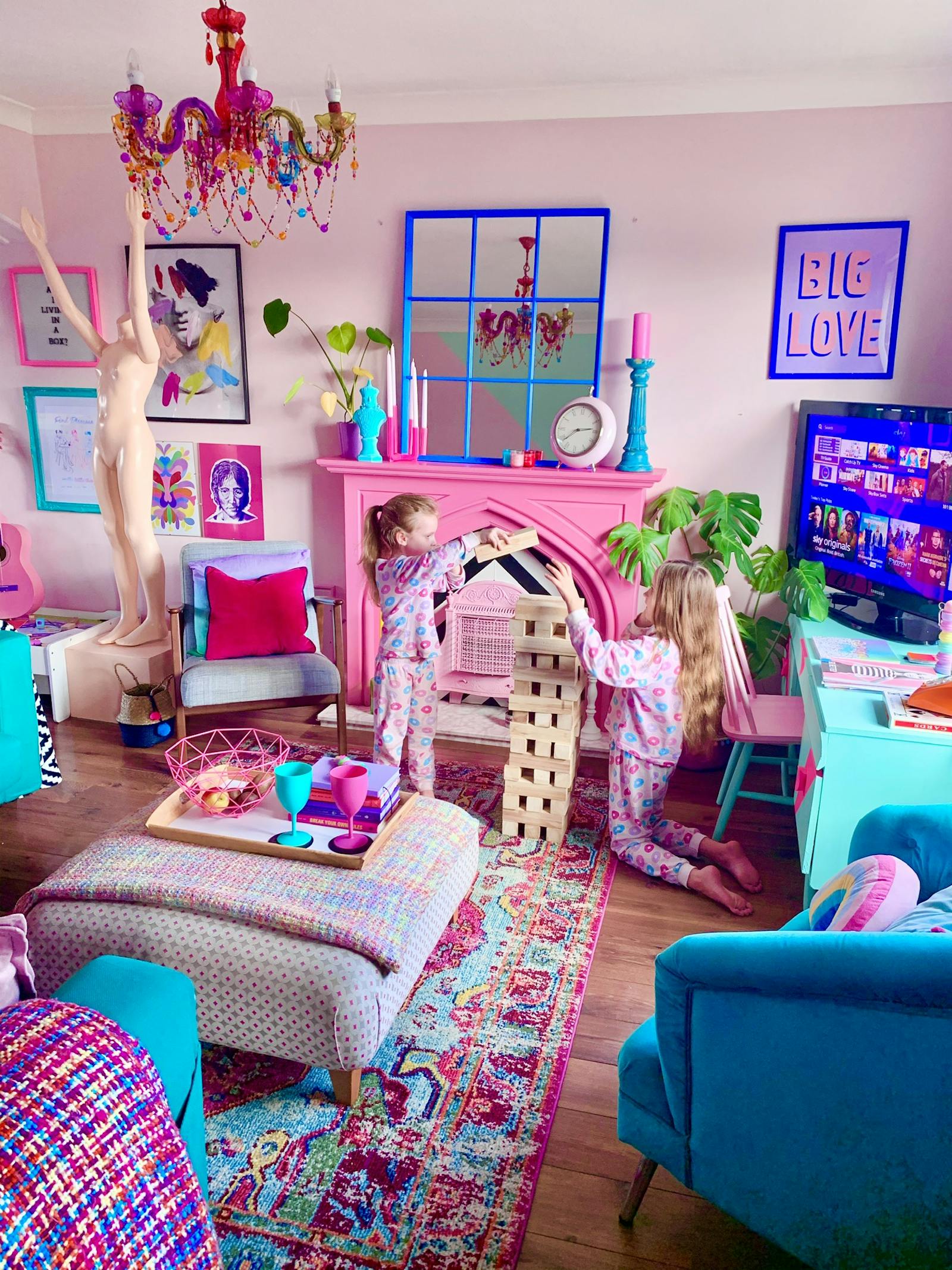 Two kids playing Jenga in a living room